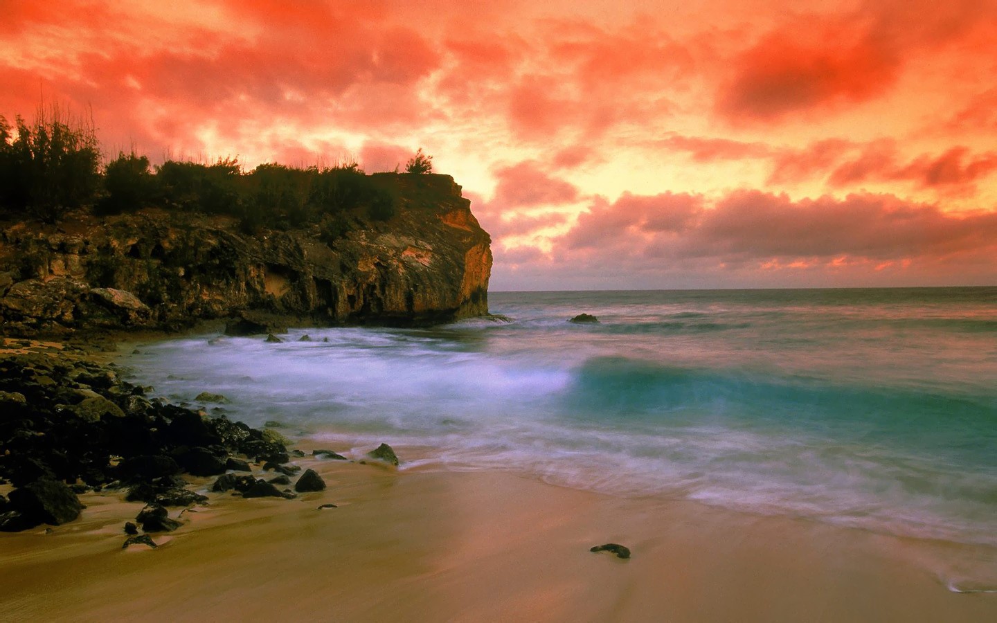 Sunset over a rocky beach with crashing waves HD Wallpaper