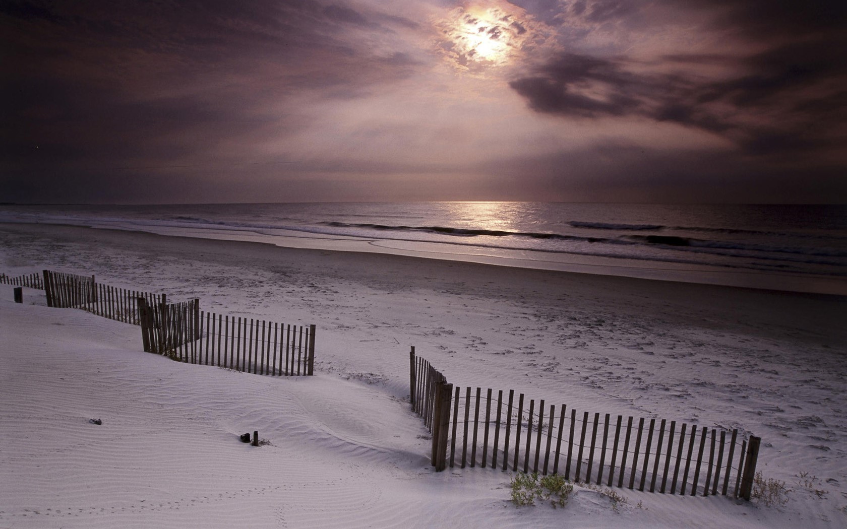 Beach fence at dusk with moonlit sky HD Wallpaper
