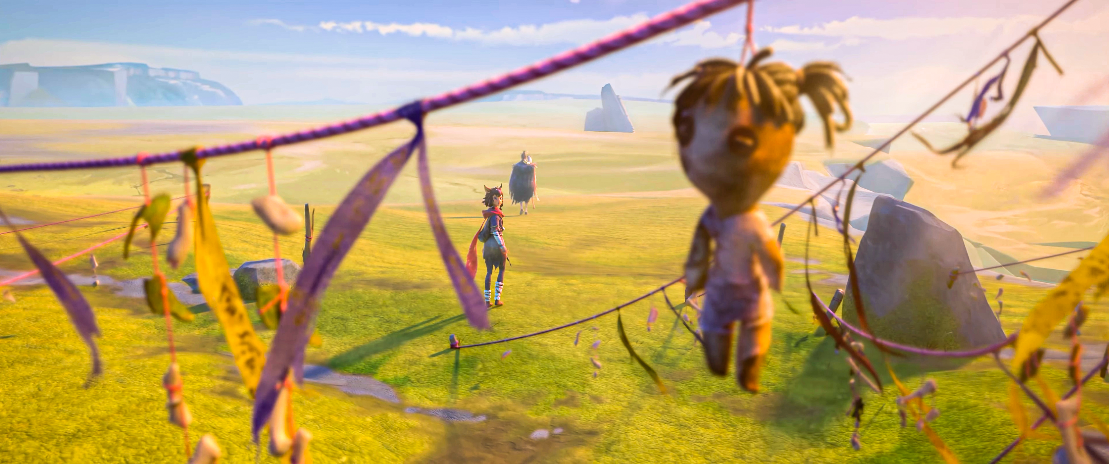 A doll hangs from a string in front of two figures in a field HD Wallpaper