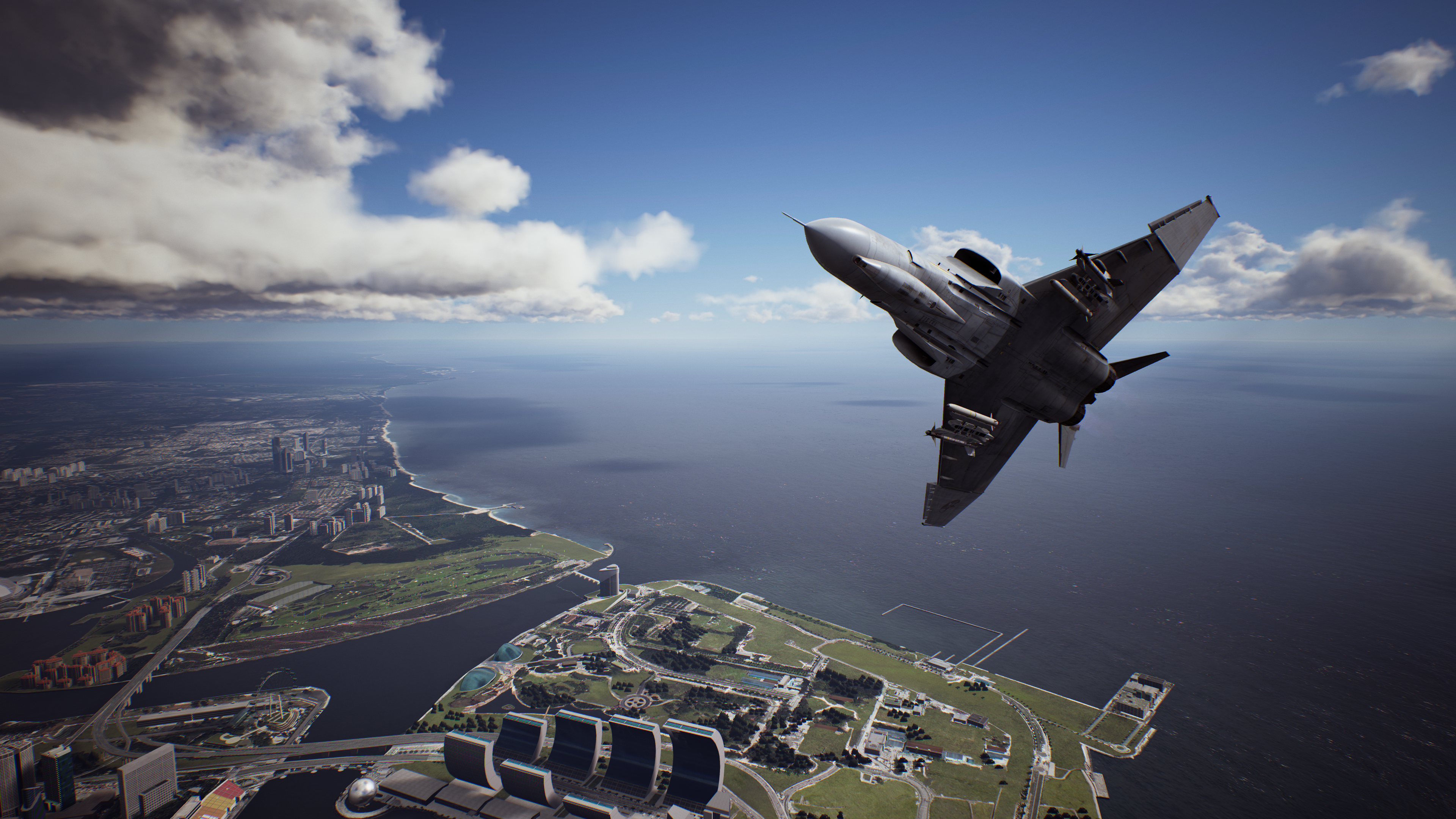 F-4 Phantom II flying over a coastal city HD Wallpaper