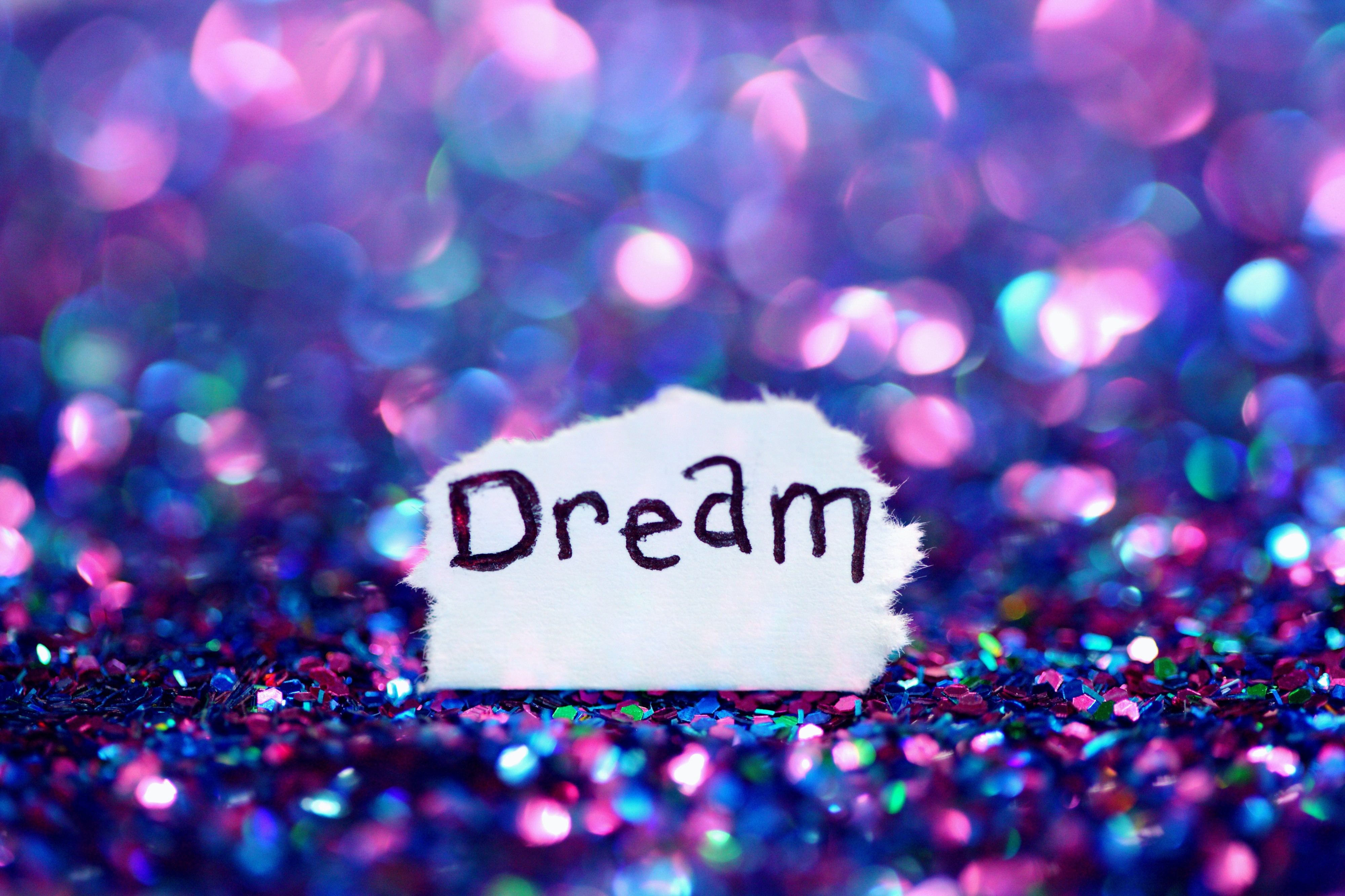 Dream written on paper with bokeh background HD Wallpaper