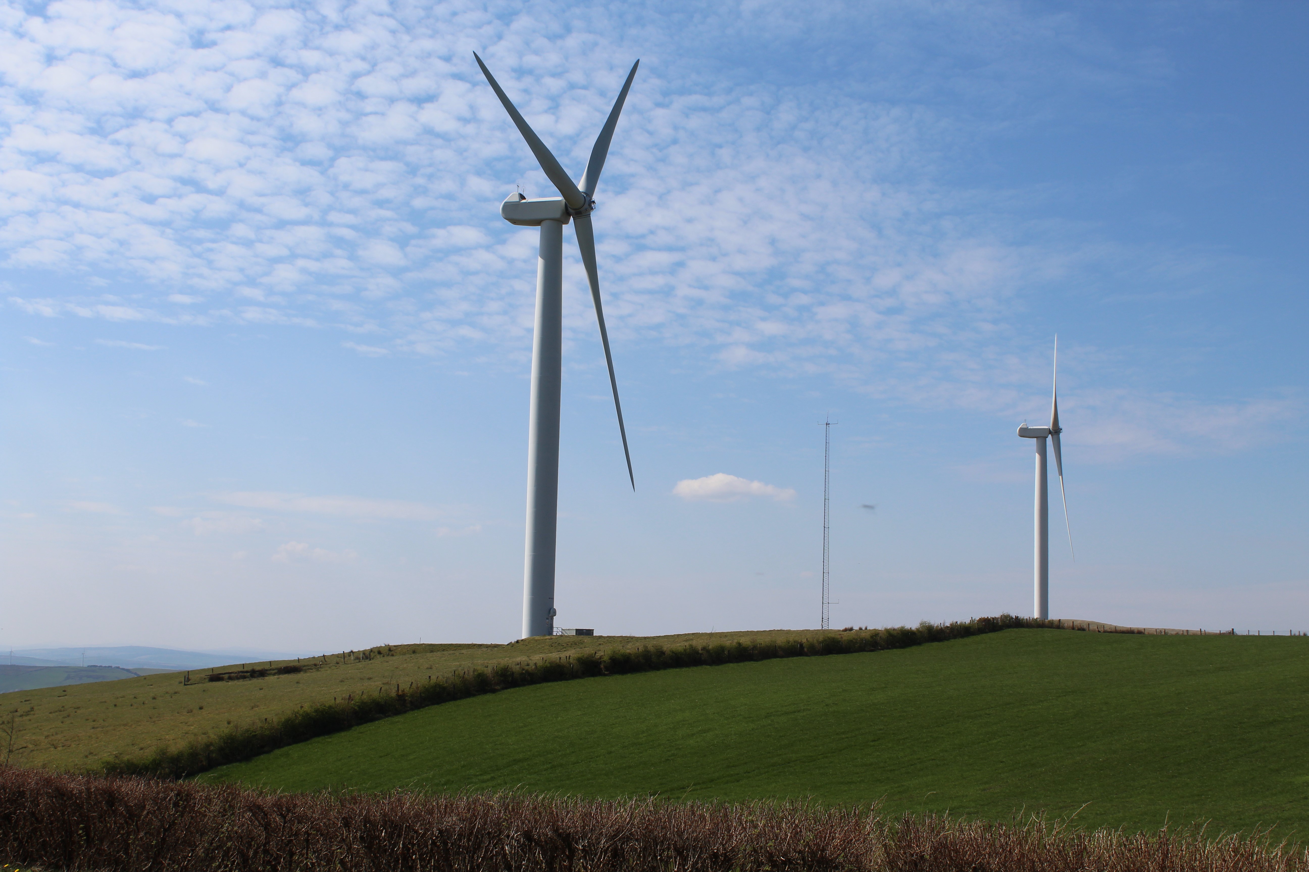 Windmills on a green hill in Ireland HD Wallpaper