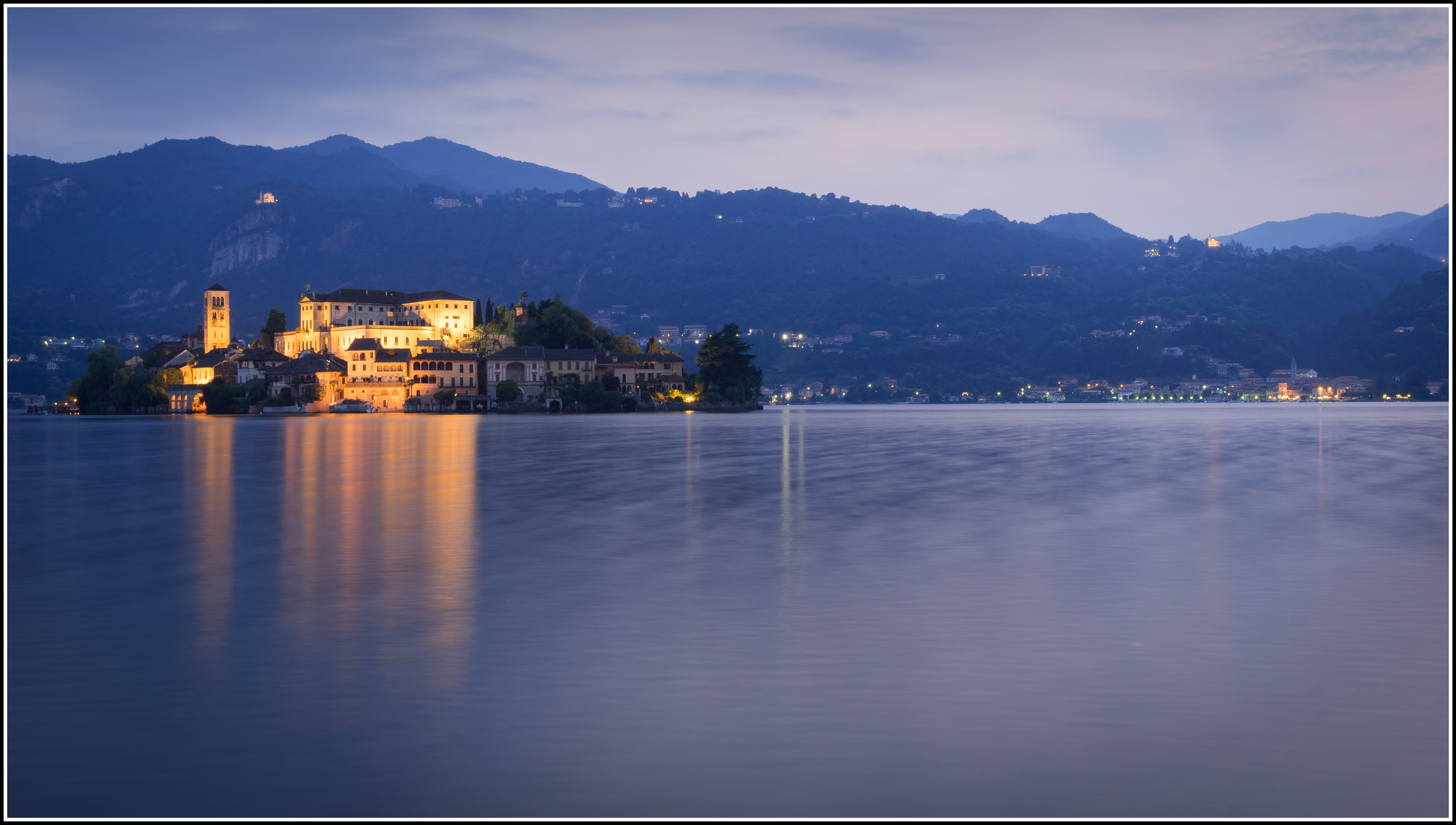 Island town on a lake at dusk, Italy HD Wallpaper