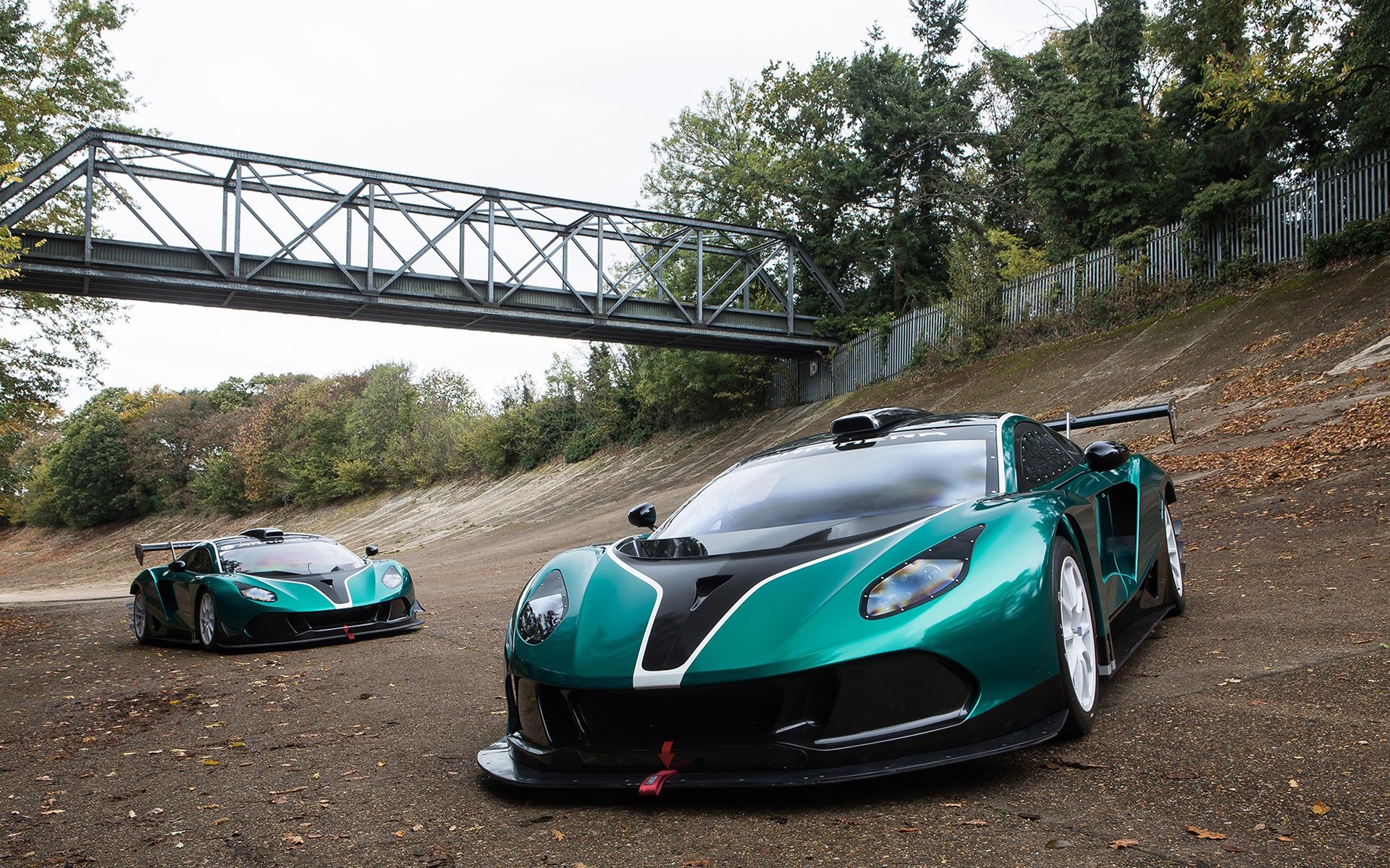 Two Arrinera Hussarya GT race cars on a banked turn HD Wallpaper