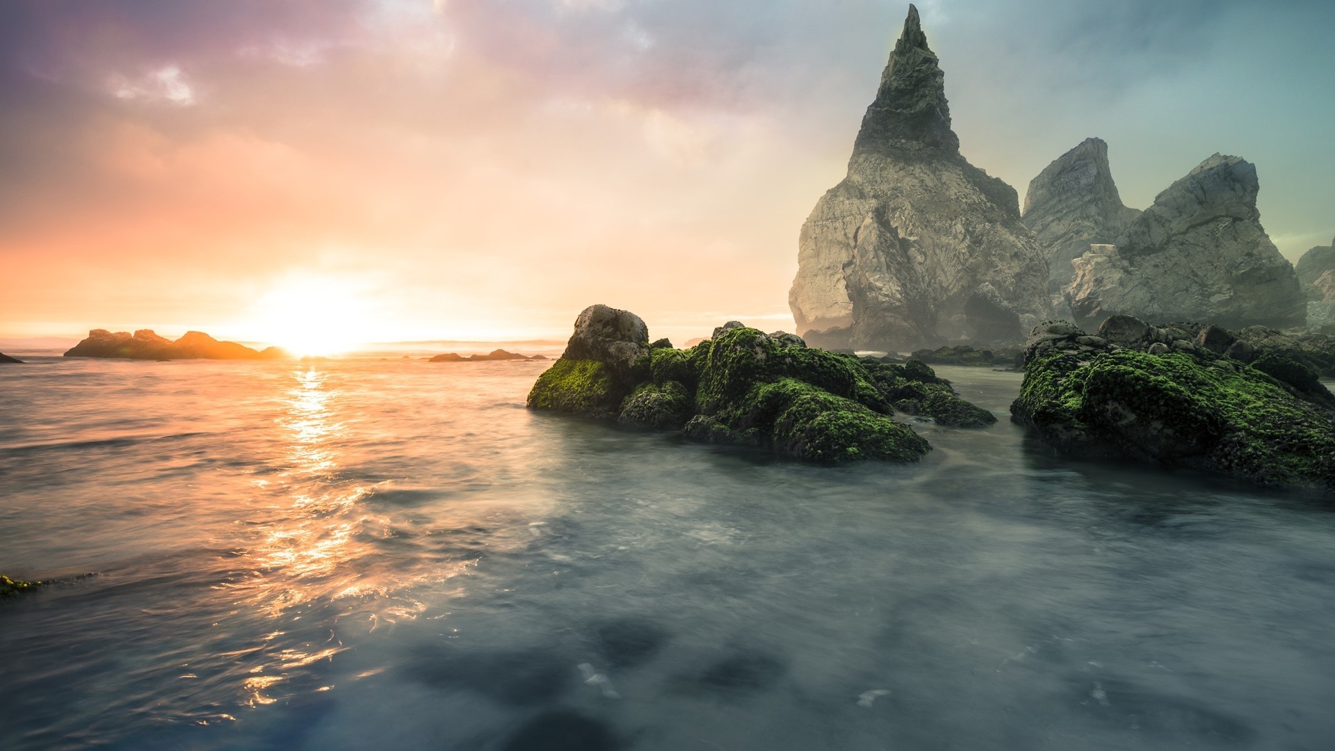 Sunset over rocky coast with mossy rocks HD Wallpaper
