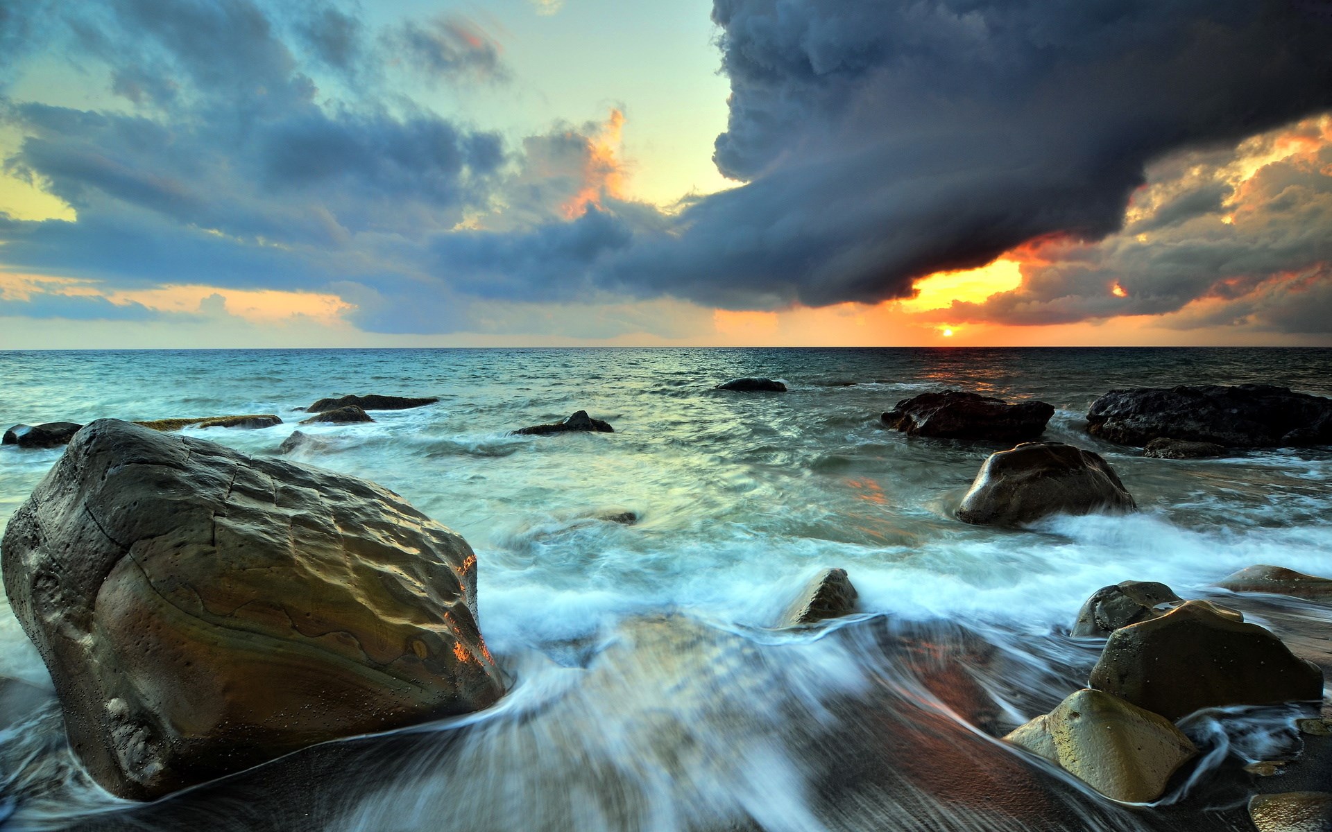 Stormy sunset over a rocky ocean shore HD Wallpaper