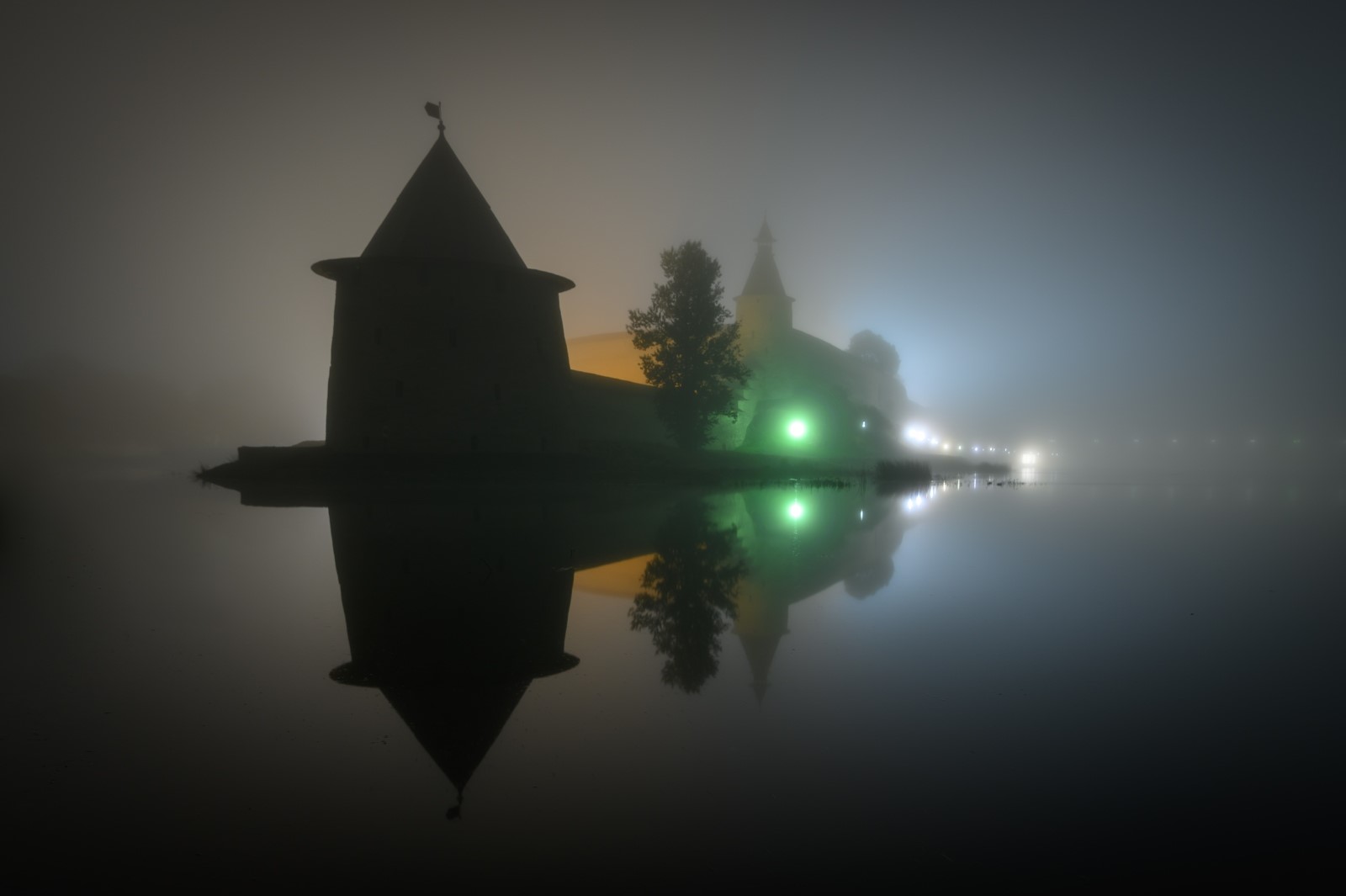 Castle and tower reflected in water at night in mist HD Wallpaper