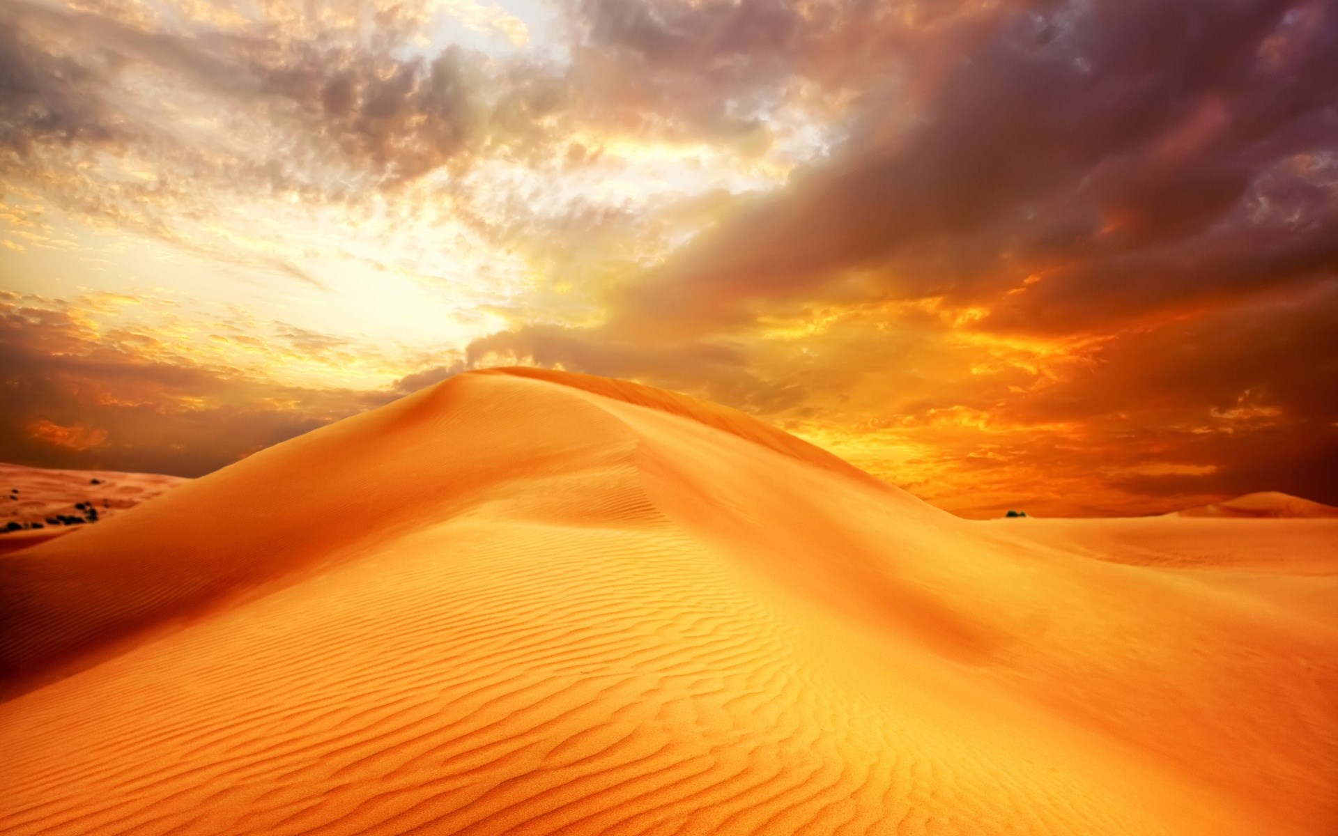 Desert dunes under a dramatic sunset sky HD Wallpaper