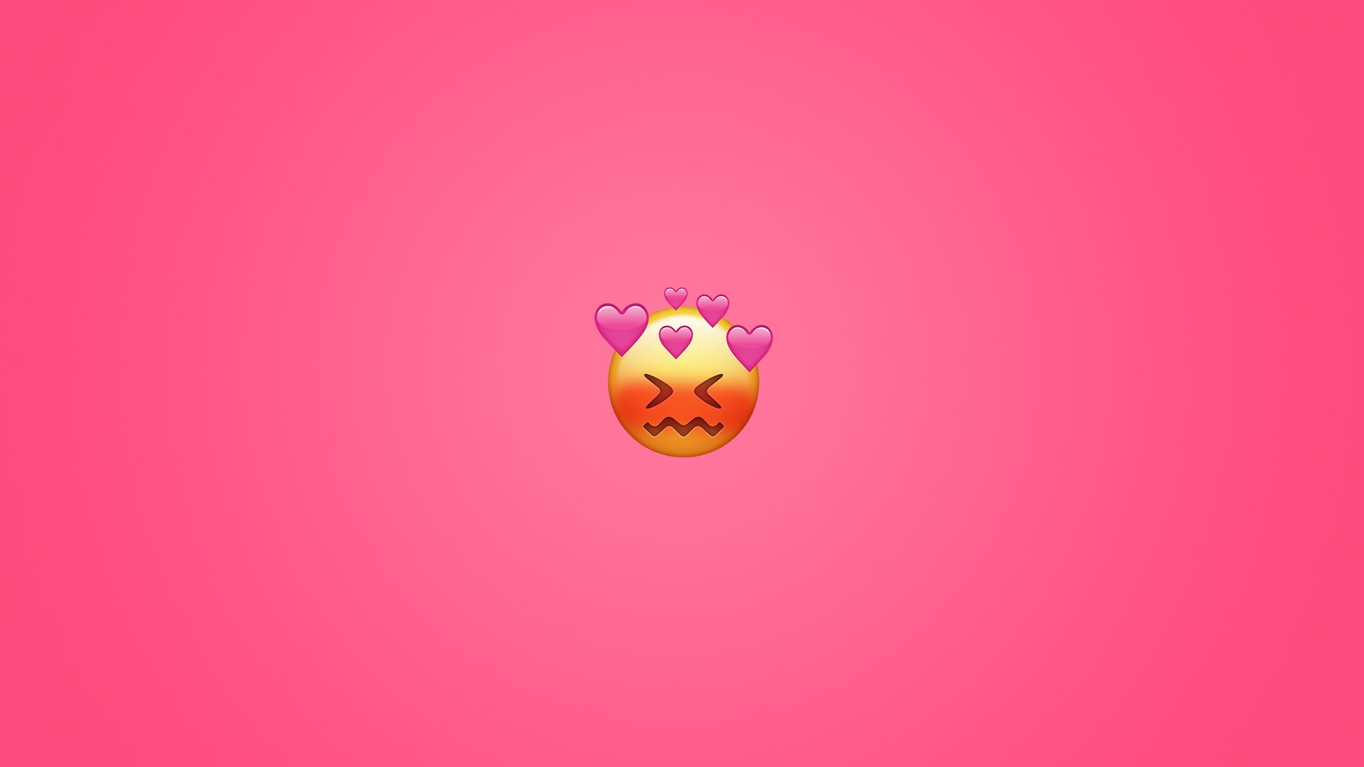 Blushing emoji with hearts on pink background HD Wallpaper