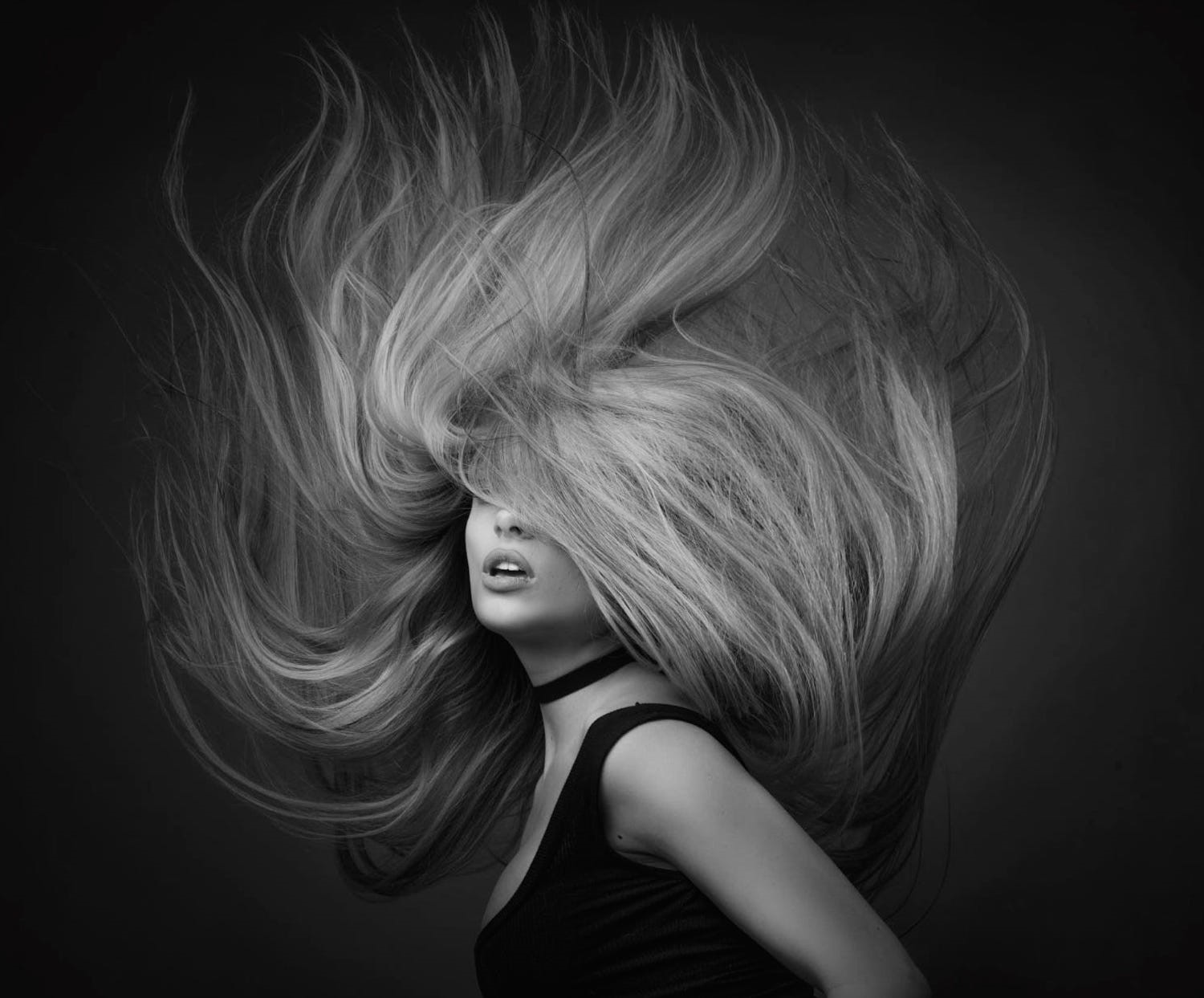 Monochrome portrait of a woman with flowing hair HD Wallpaper