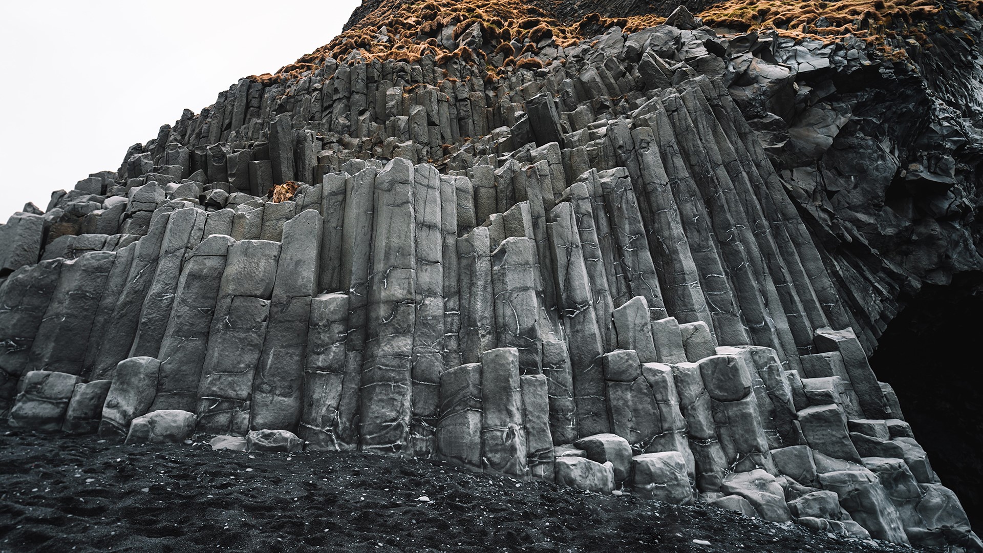 Basalt columns on a black sand beach HD Wallpaper