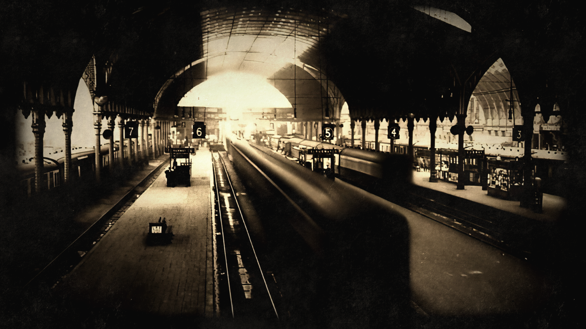 Sepia toned train station with platforms and tracks HD Wallpaper
