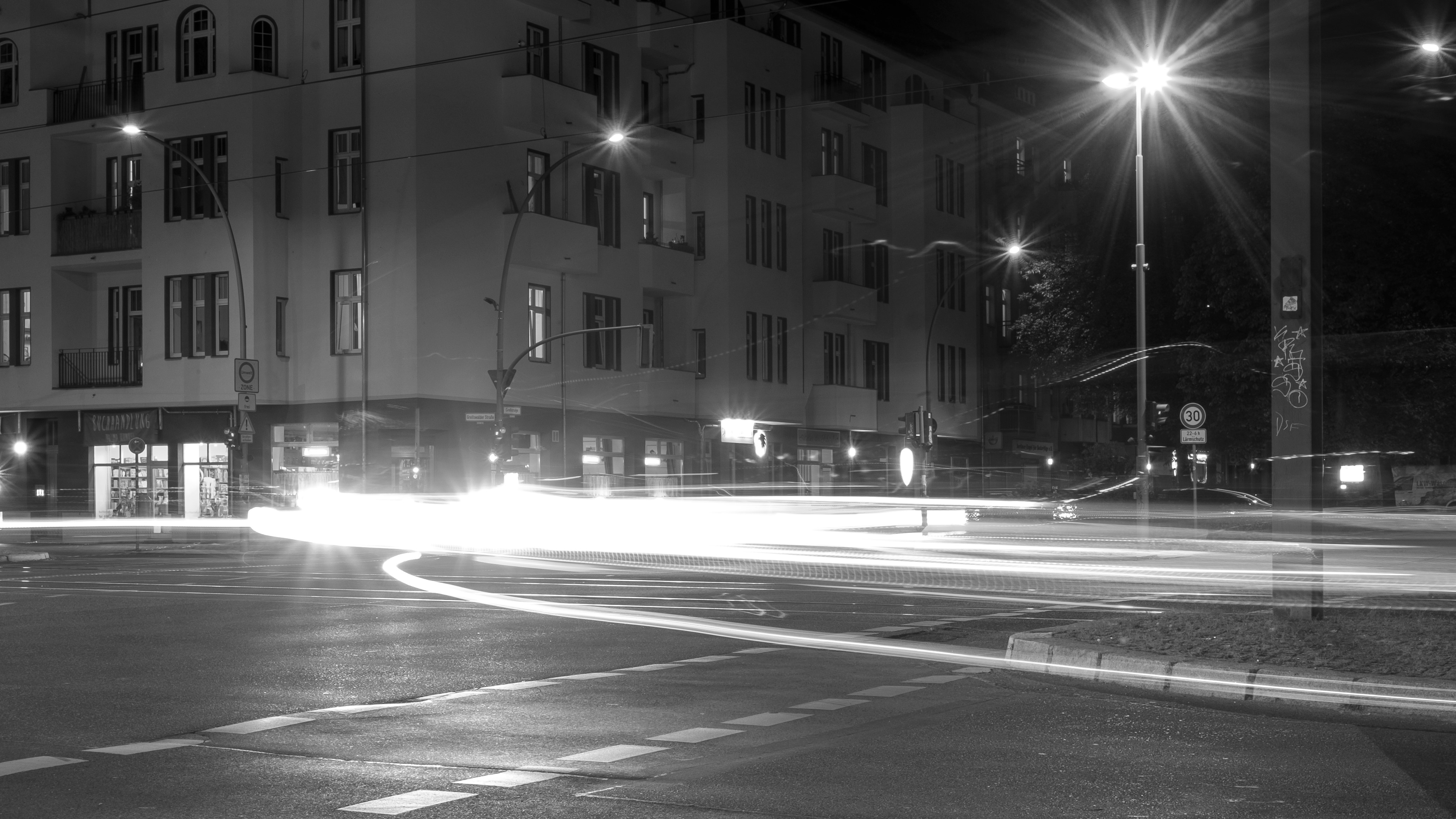 Monochrome urban street at night with light trails HD Wallpaper