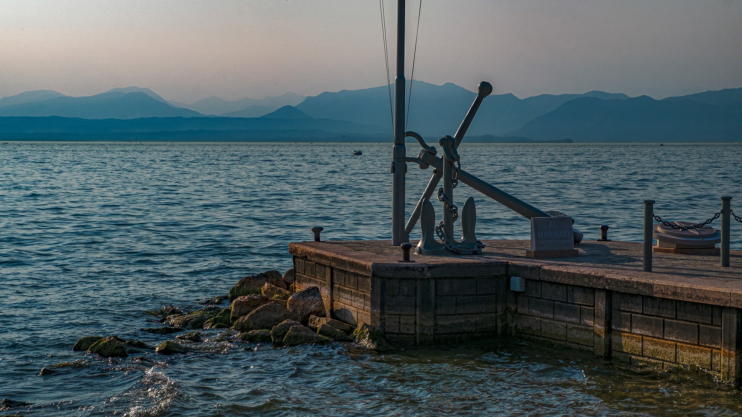 Anchor on a pier by a lake with mountains HD Wallpaper