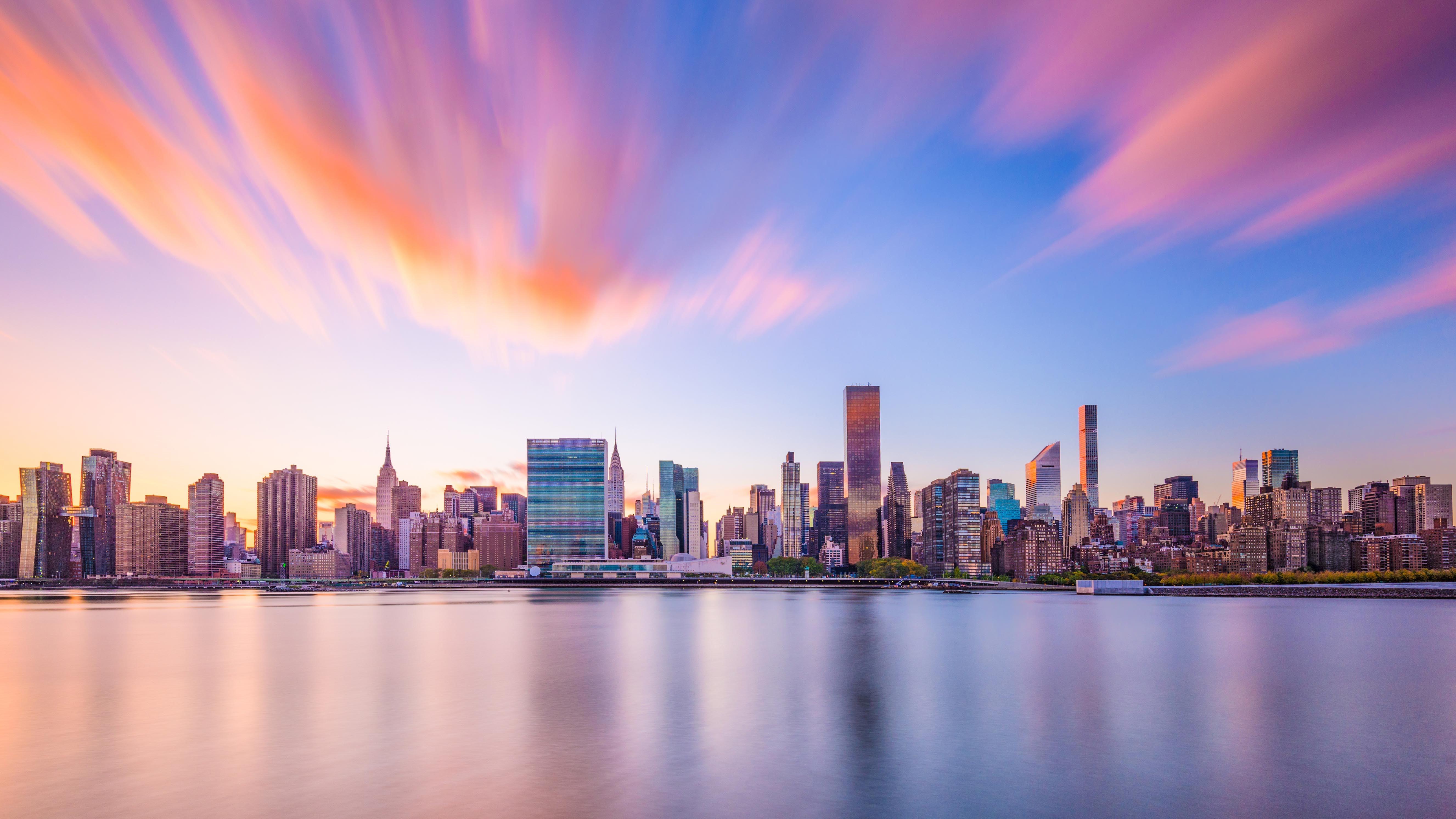 New York City skyline with long exposure clouds over East River HD Wallpaper