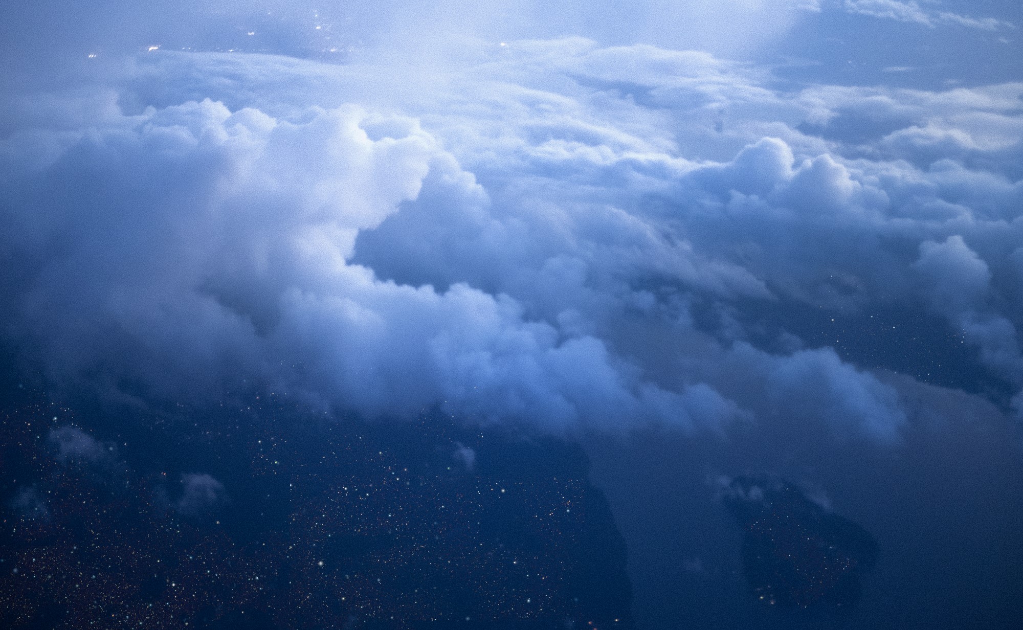 Clouds over city lights at night from above HD Wallpaper