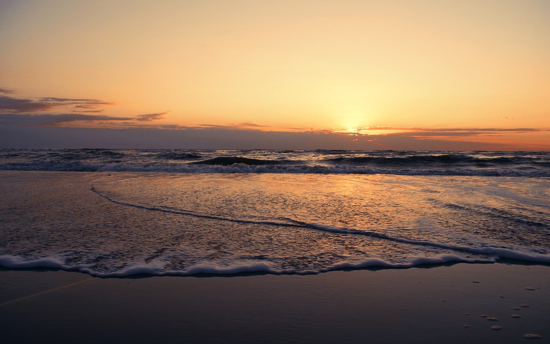 Sunset over the ocean with waves on the beach HD Wallpaper