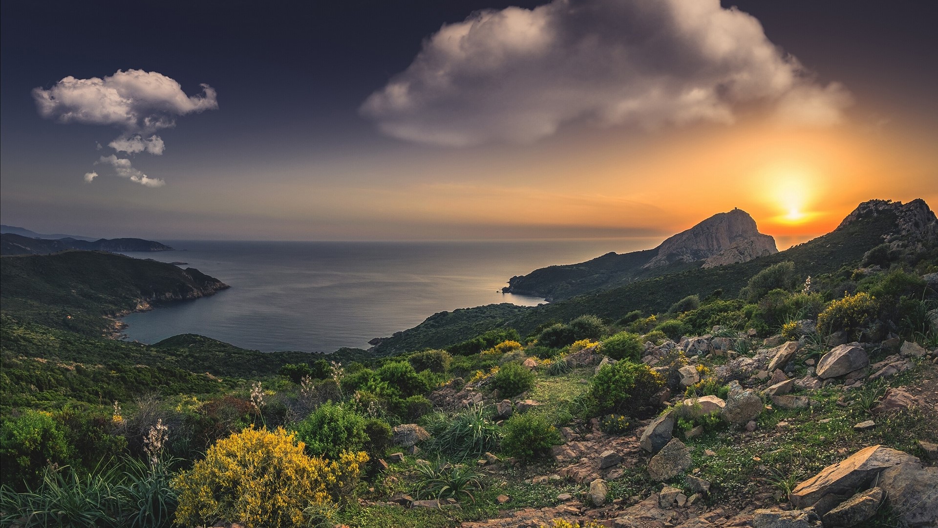 Sunset over a mountainous coastline with clouds HD Wallpaper
