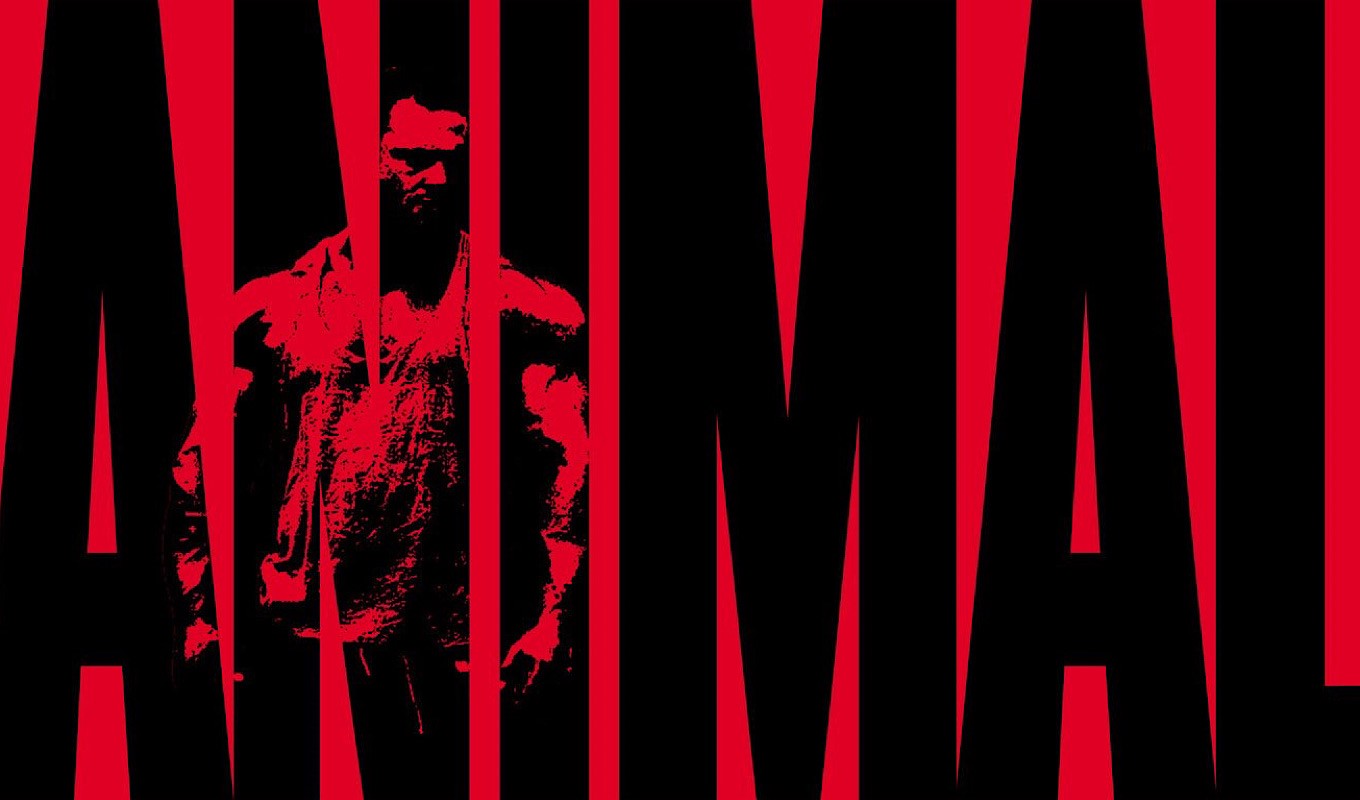 Man with muscles behind red bars HD Wallpaper