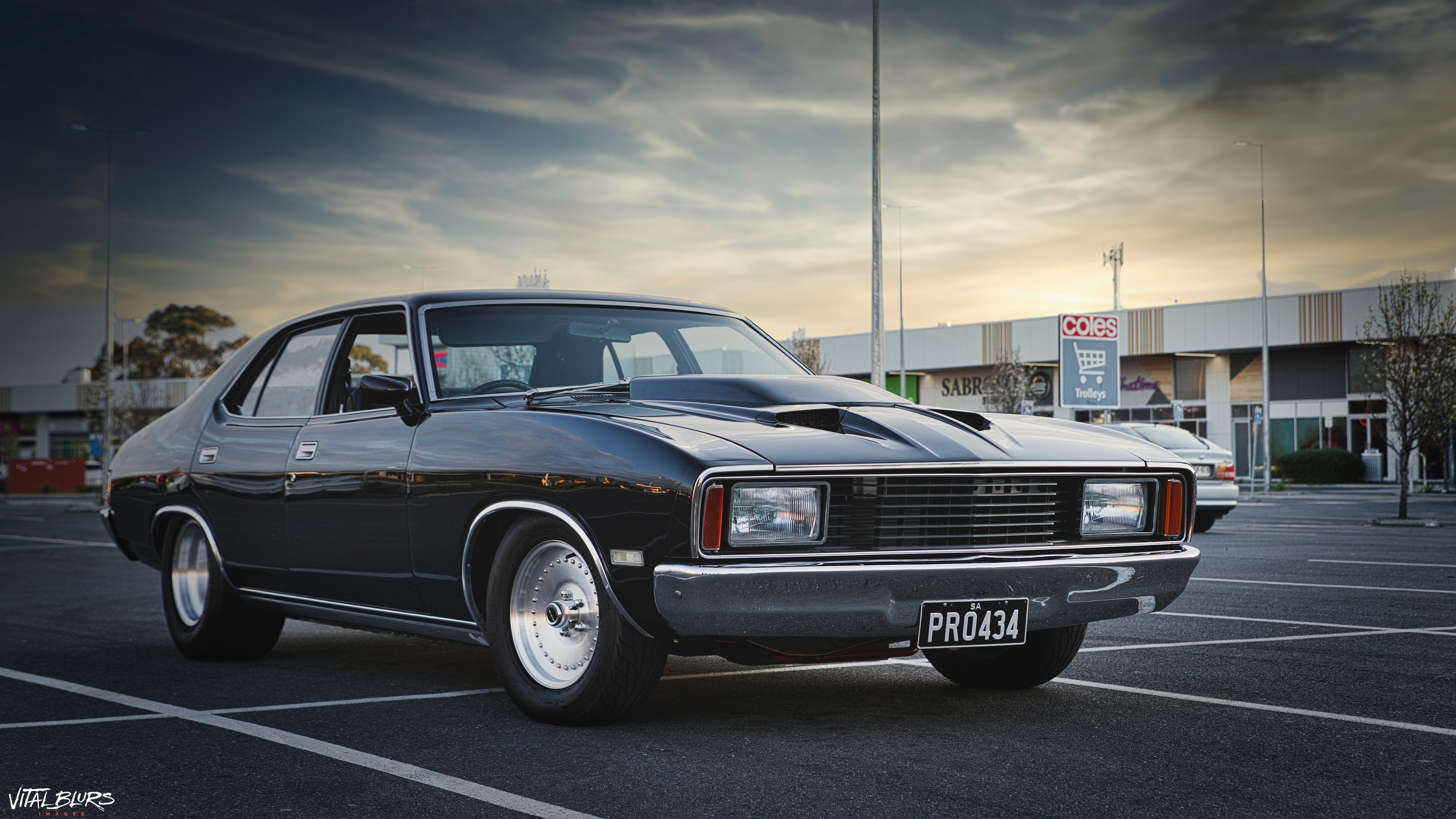 Black Ford Falcon in a car park HD Wallpaper
