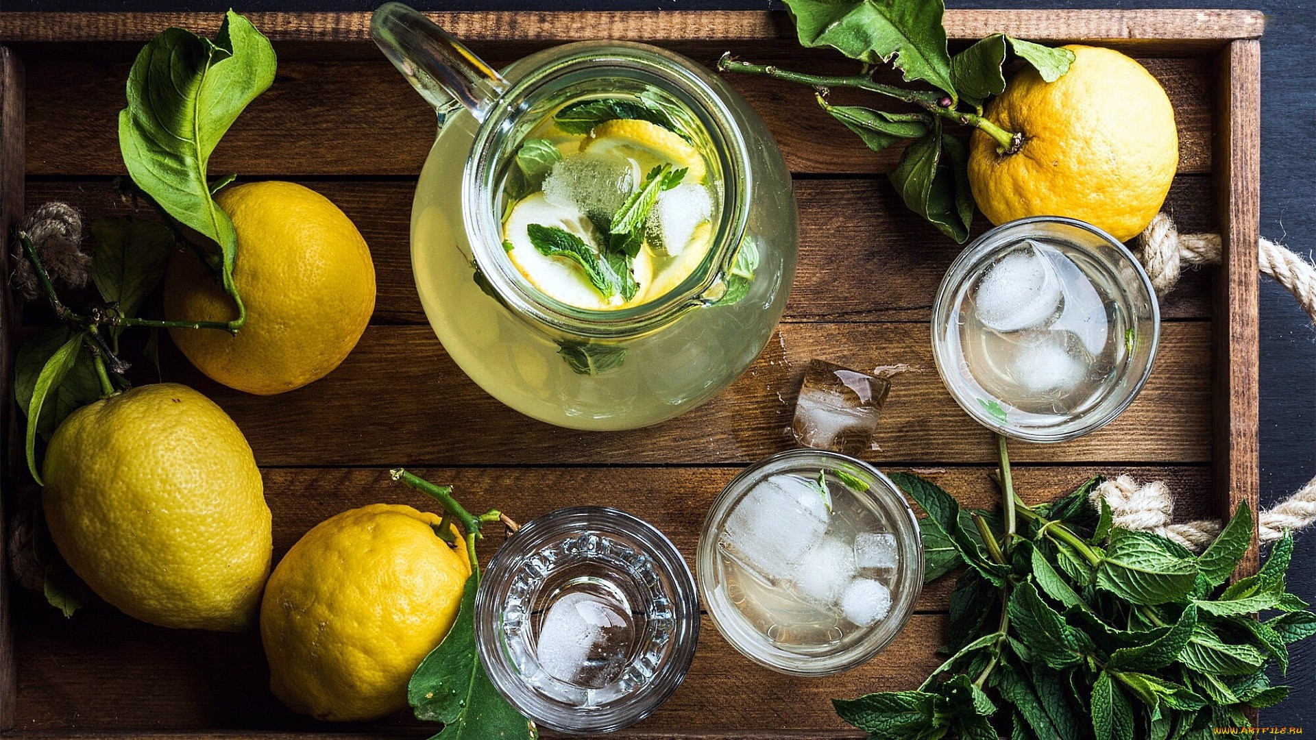 Lemonade with mint and ice in a pitcher and glasses HD Wallpaper