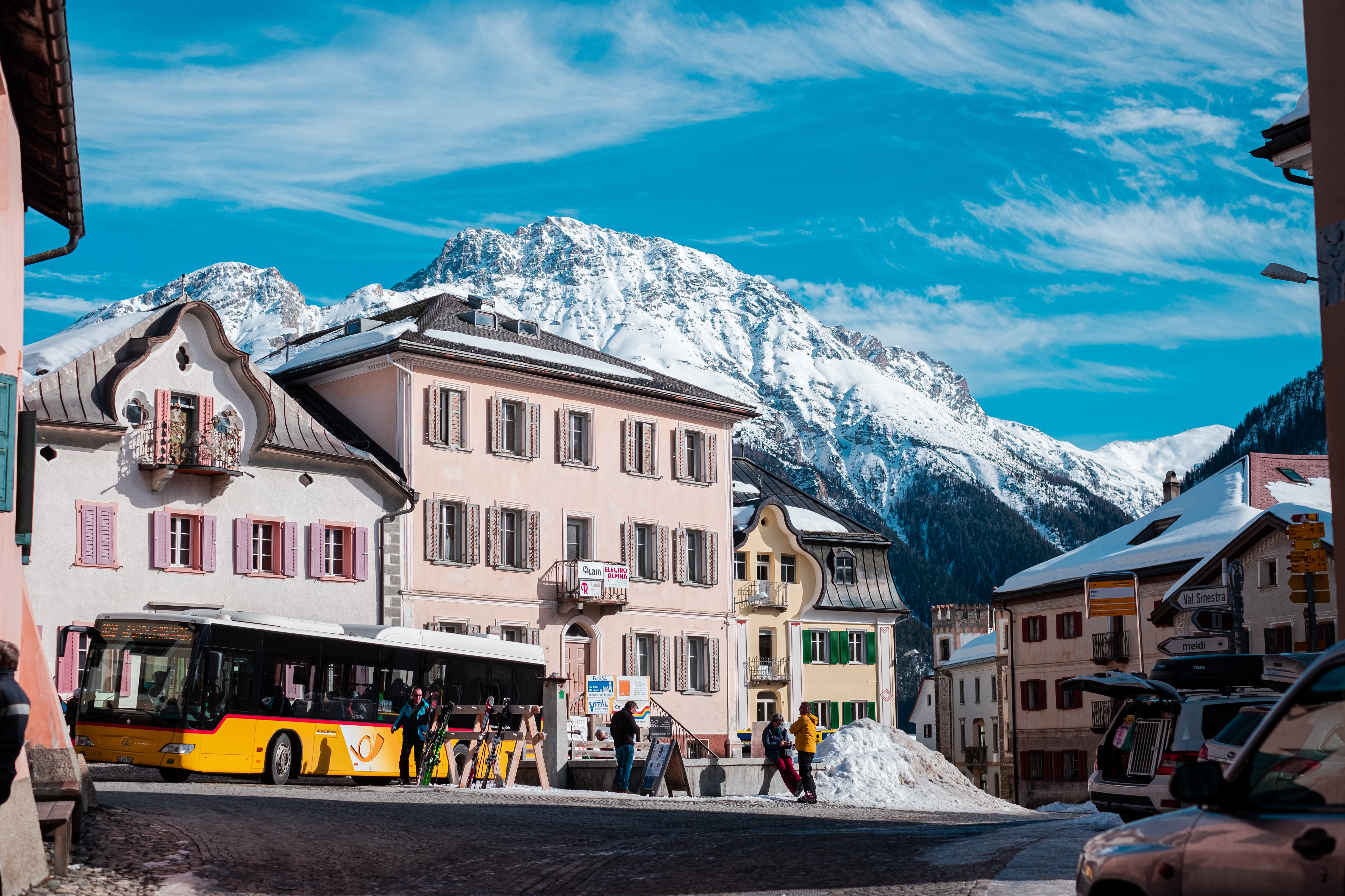 Yellow bus in a Swiss mountain town HD Wallpaper