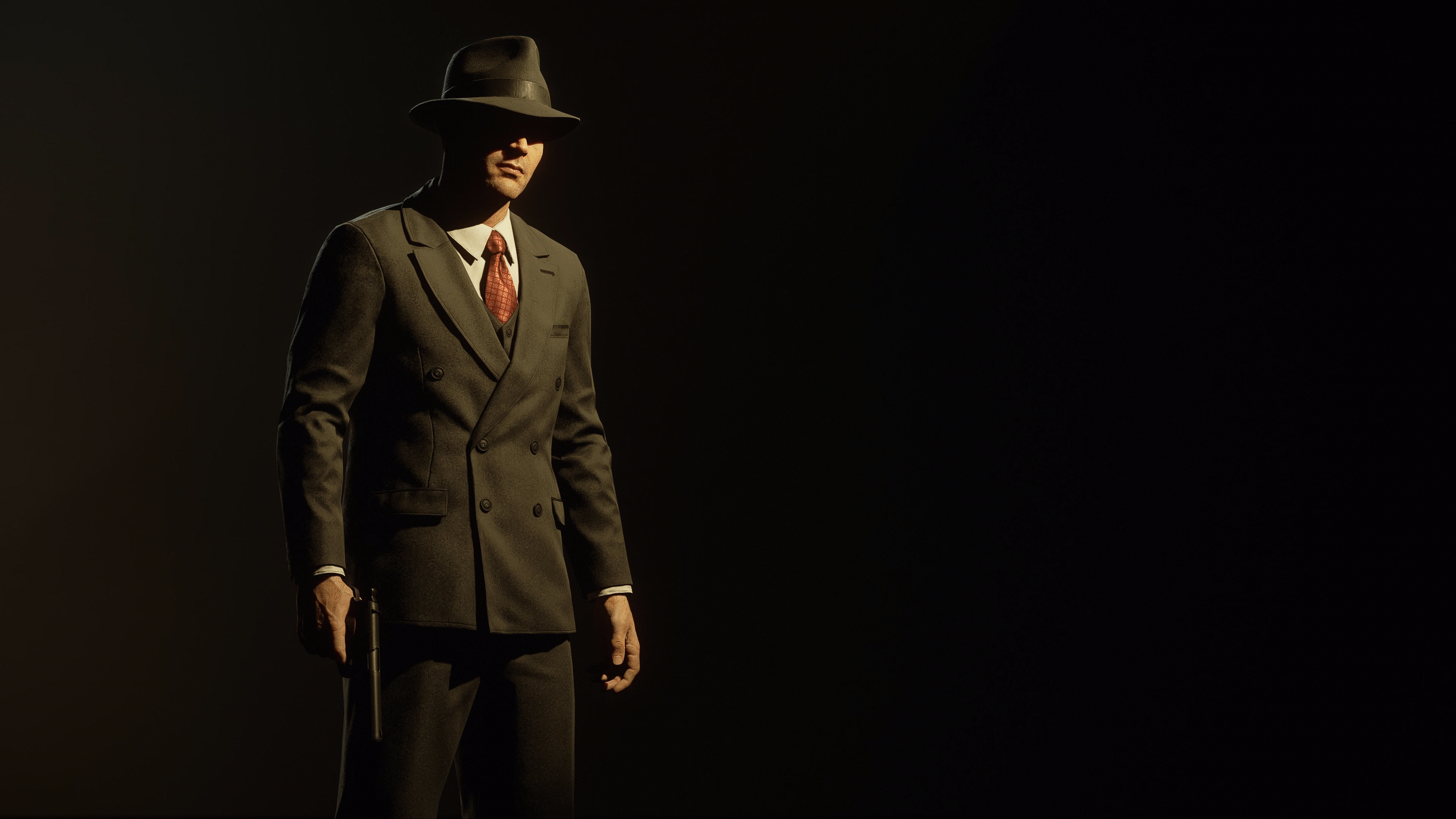 Man in suit and hat holding a gun HD Wallpaper