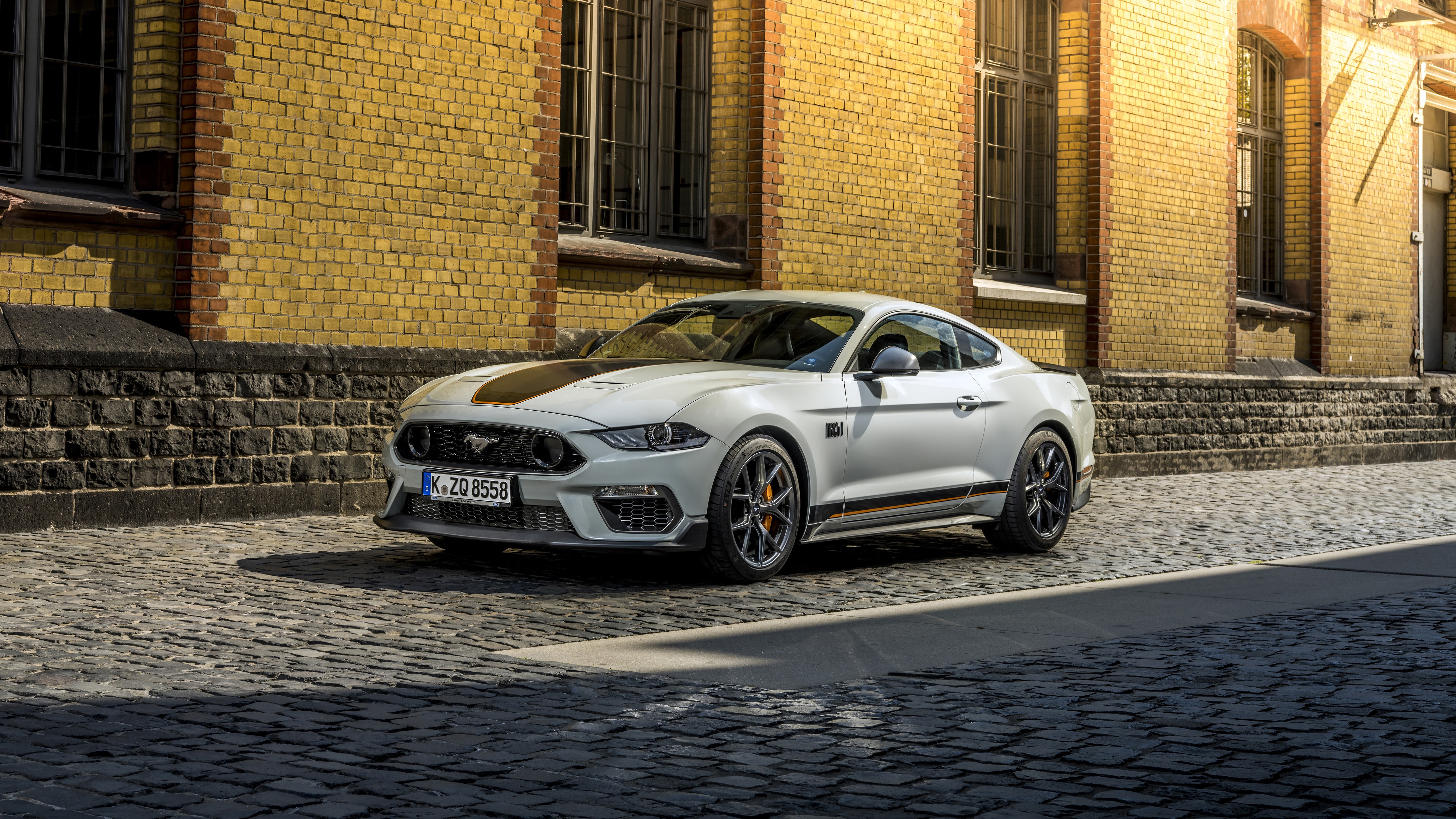 White Ford Mustang Mach 1 on cobblestone street HD Wallpaper