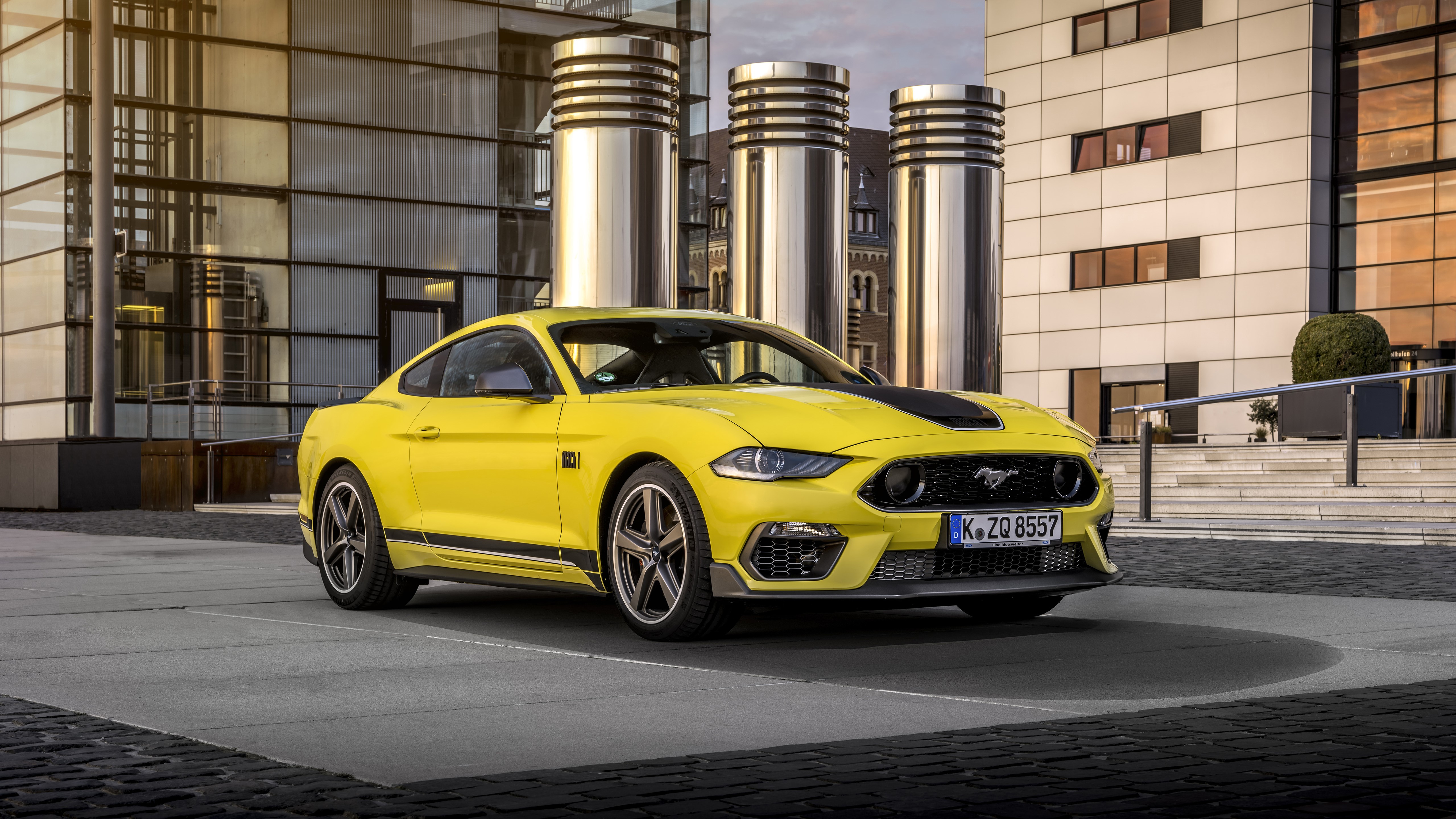 Yellow Ford Mustang Mach 1 parked in front of modern building HD Wallpaper