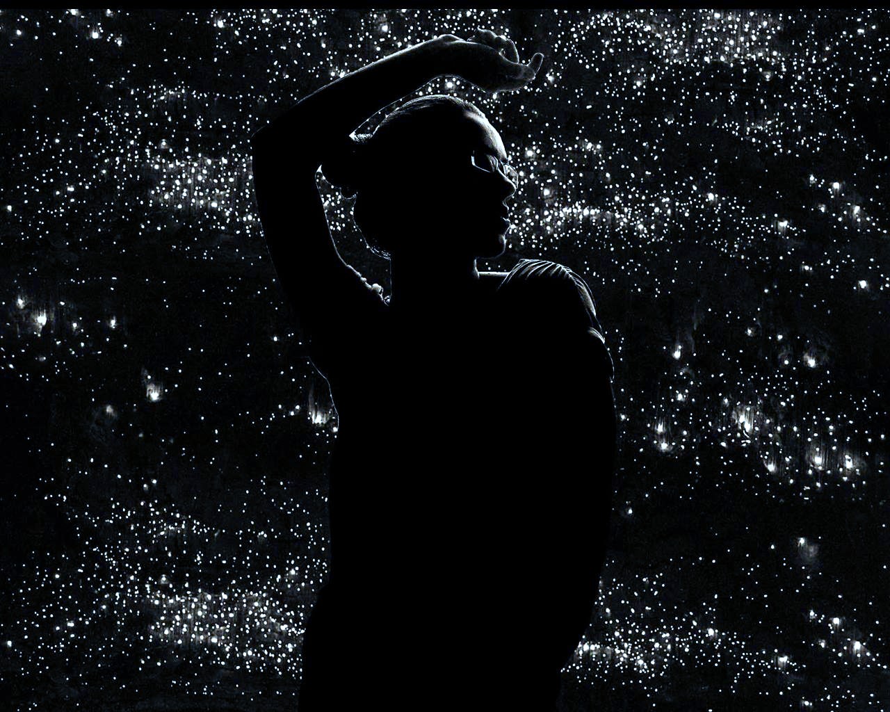 Silhouette of a woman with glasses against a starry background HD Wallpaper