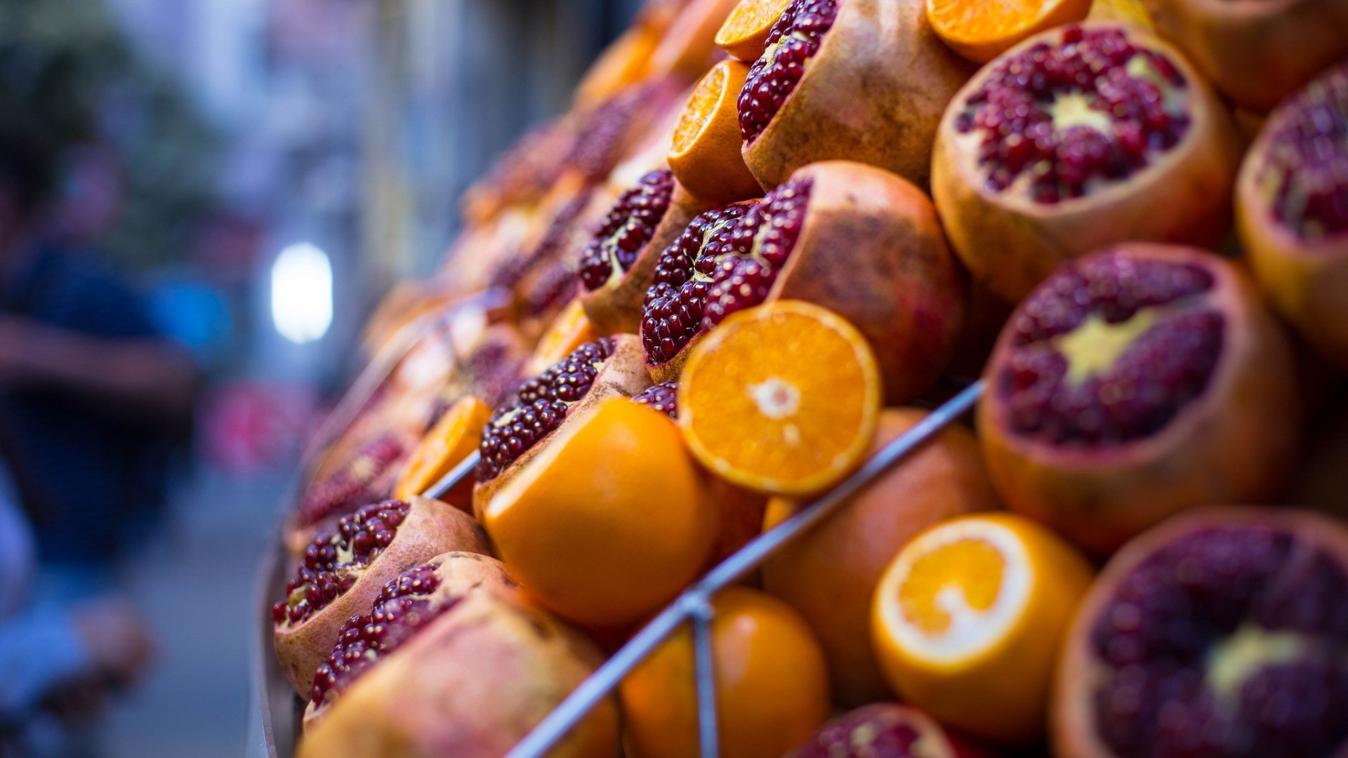 Pomegranates and oranges at a market stall HD Wallpaper