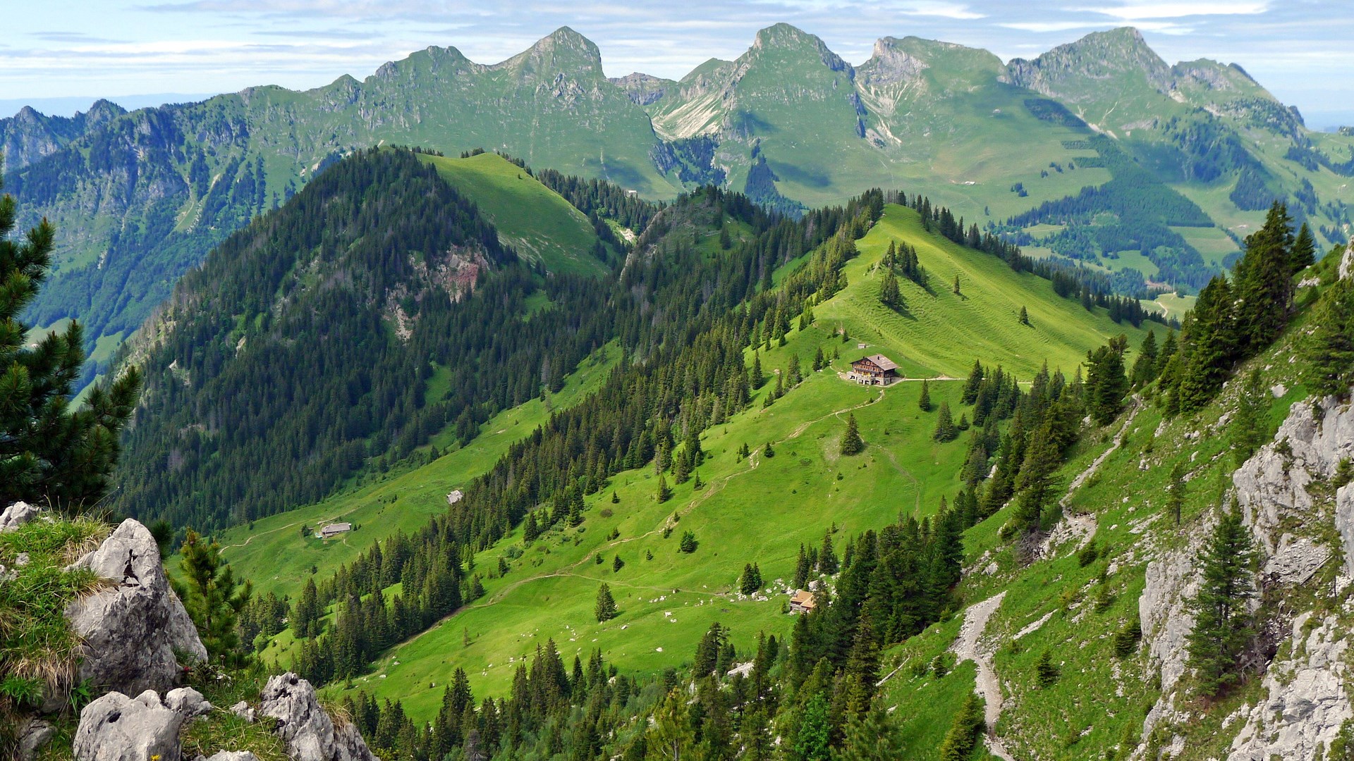 Green mountain landscape with houses and trees HD Wallpaper