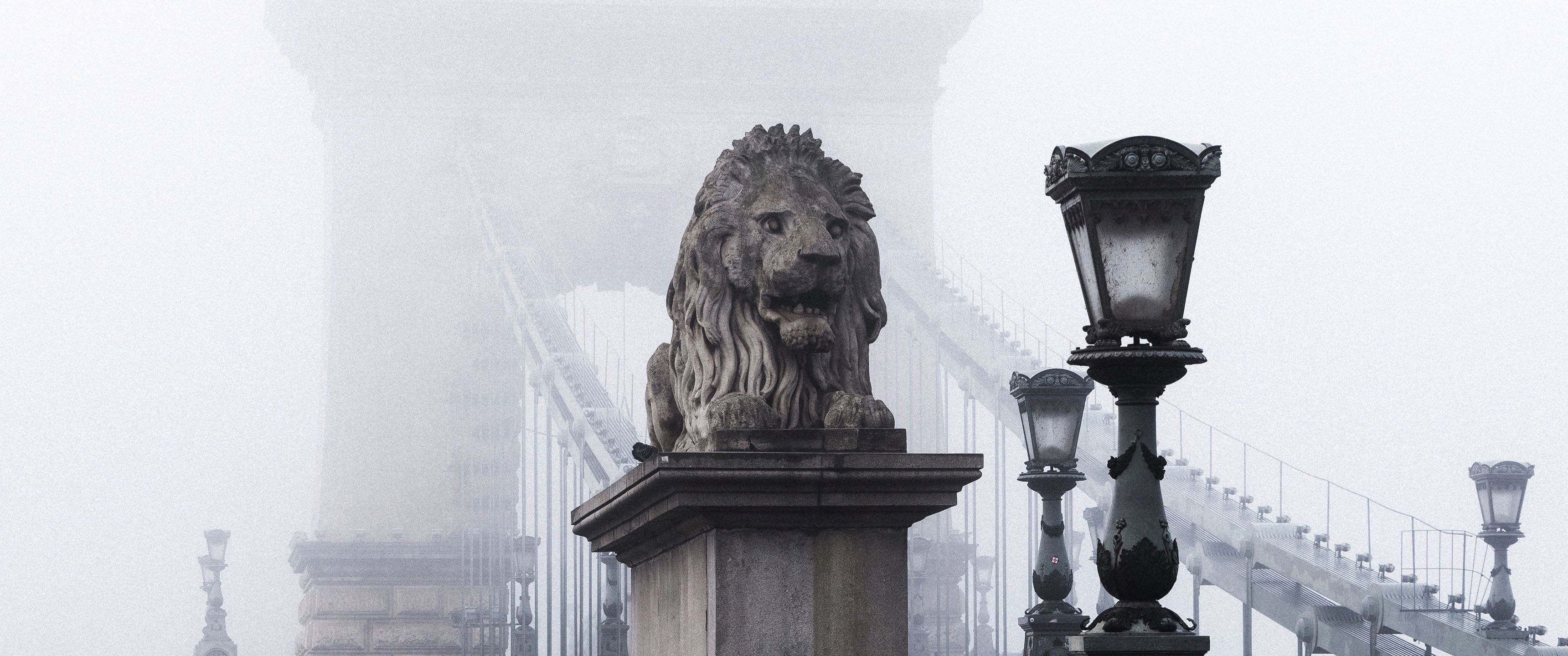 Stone lion statue on a bridge in the mist HD Wallpaper