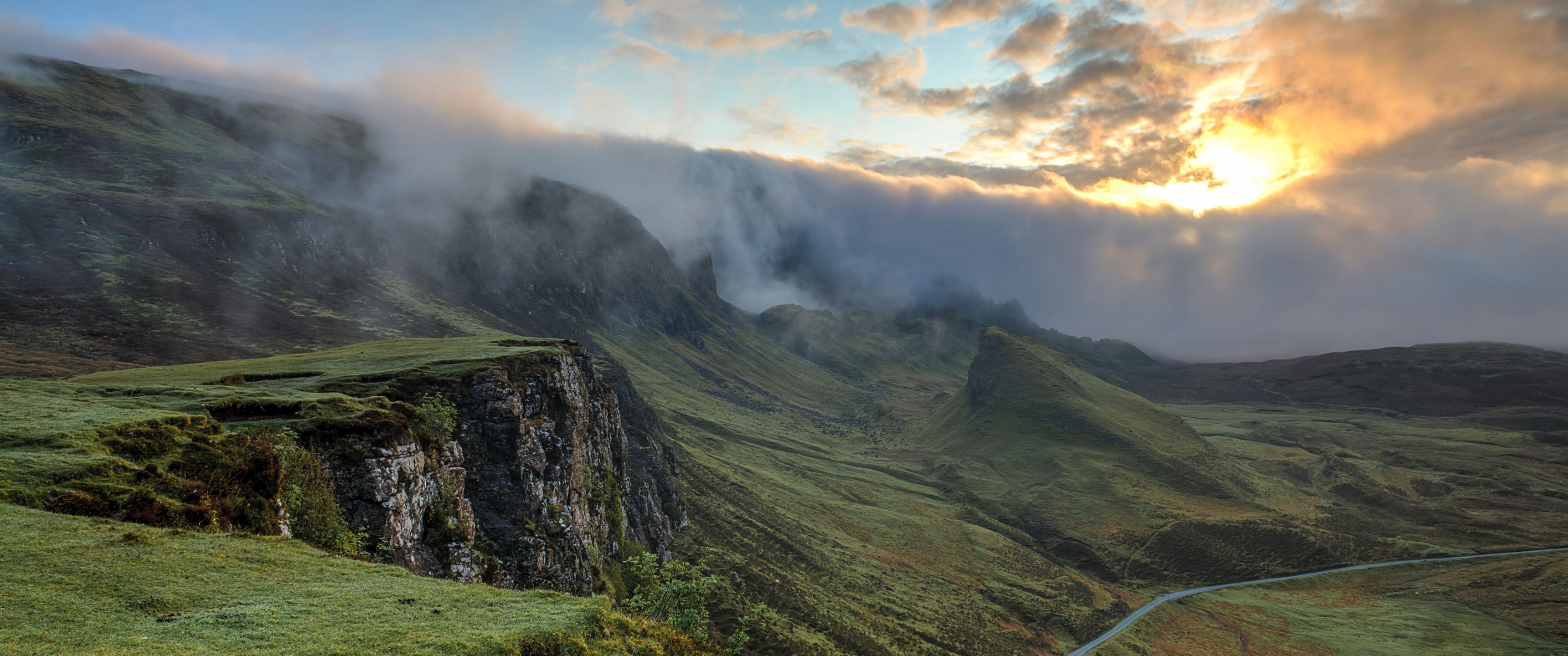 Misty mountains with sunlight breaking through clouds HD Wallpaper