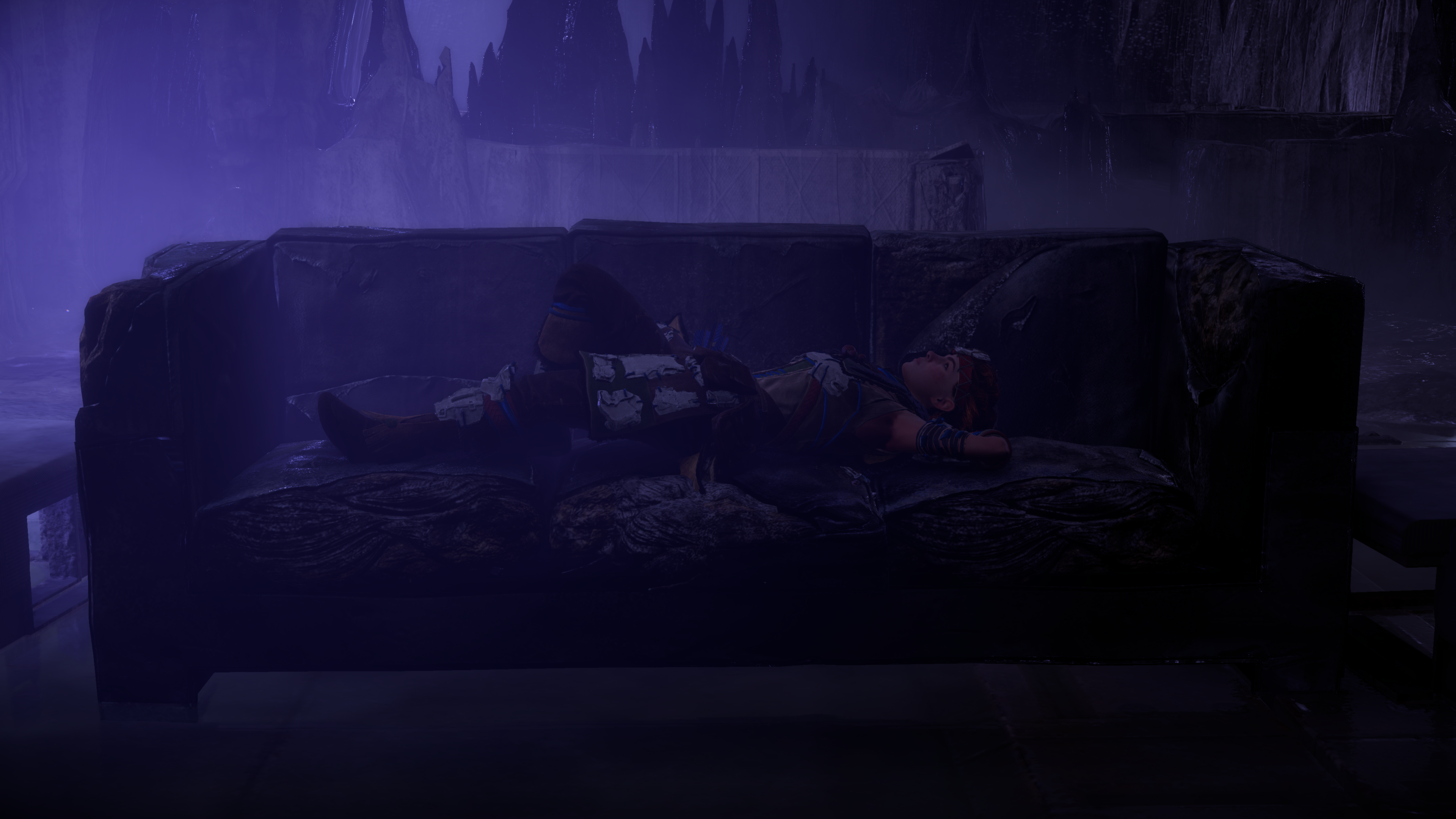 Aloy from Horizon Zero Dawn lying on a couch in a cave HD Wallpaper