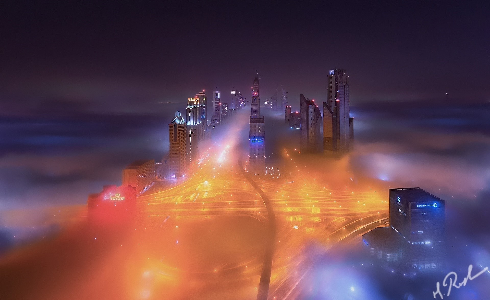 Dubai cityscape at night with fog and lights HD Wallpaper