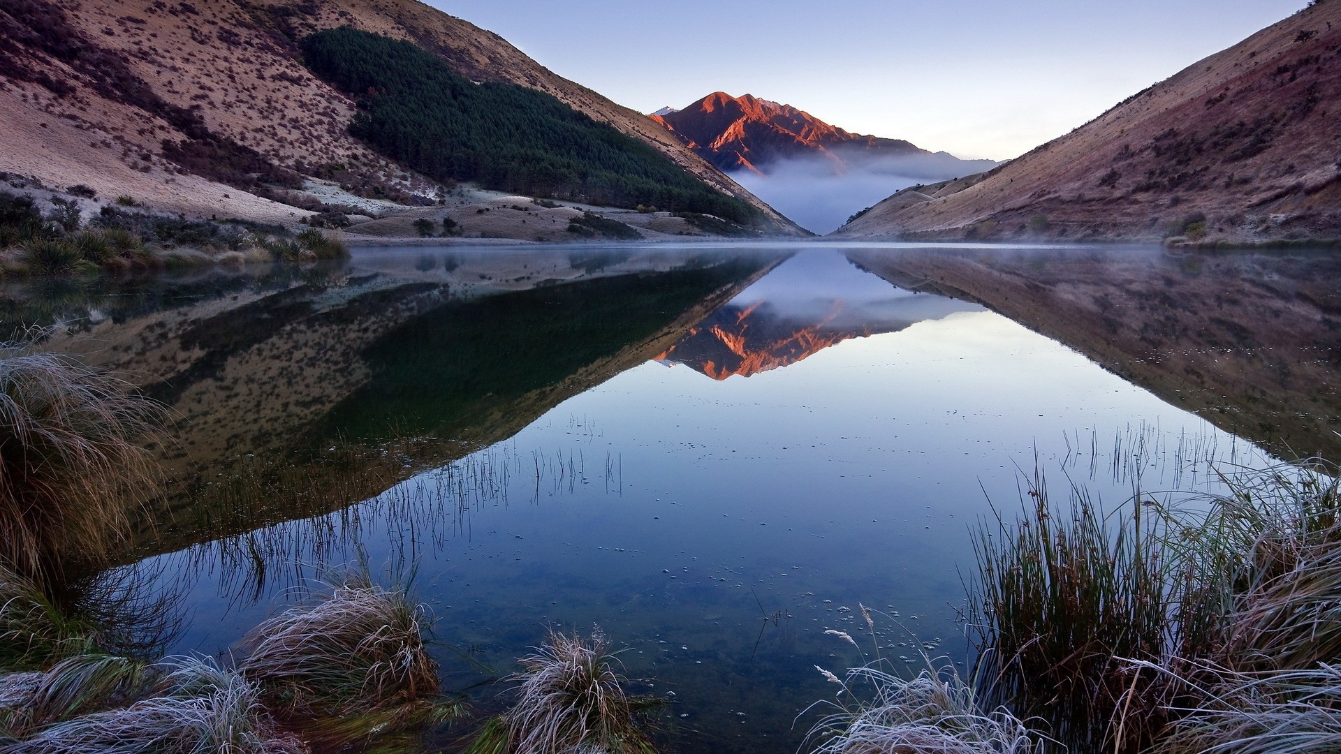 Mountain lake reflection at sunrise with mist HD Wallpaper