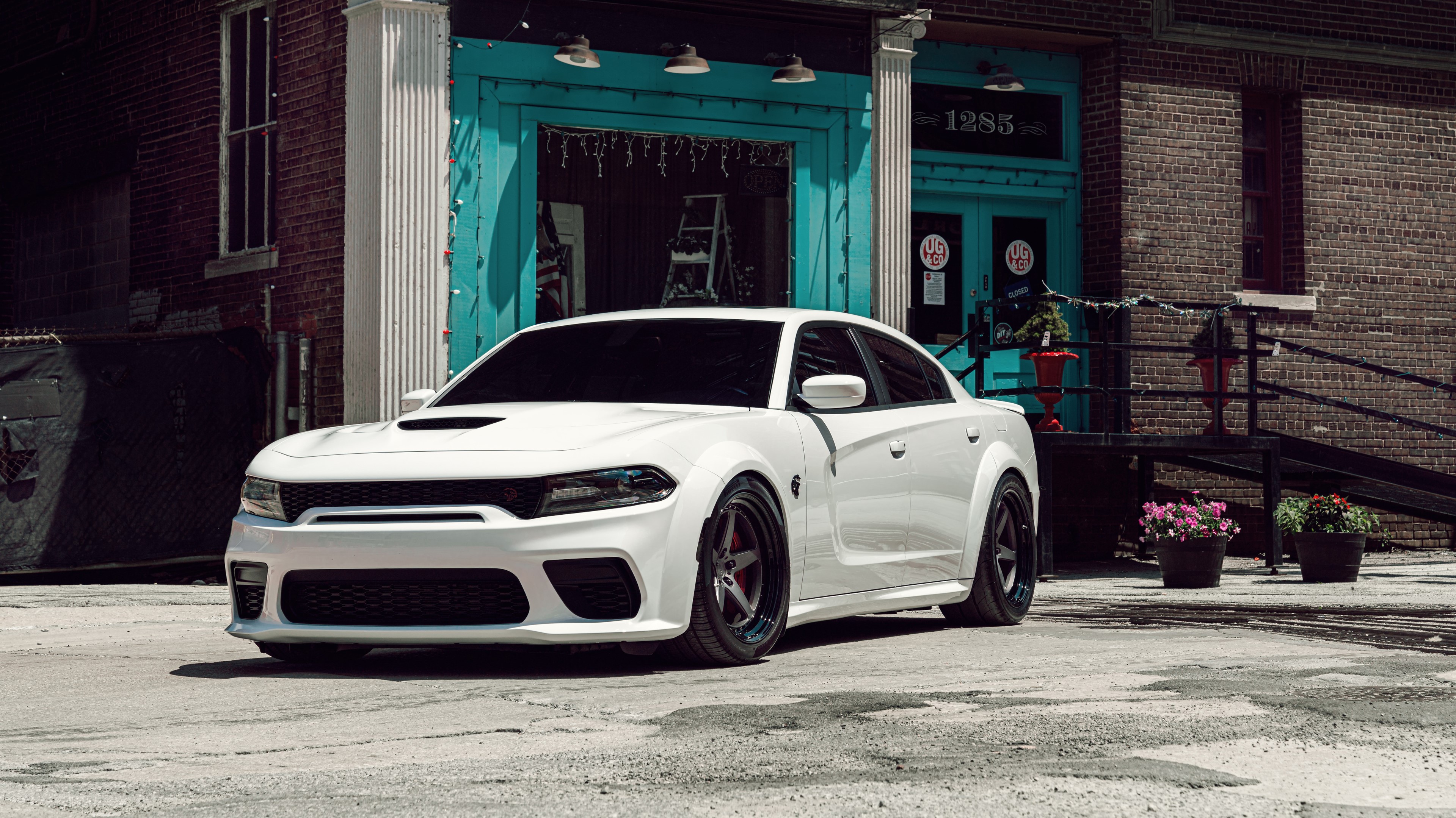 White Dodge Hellcat car parked in front of a brick building HD Wallpaper