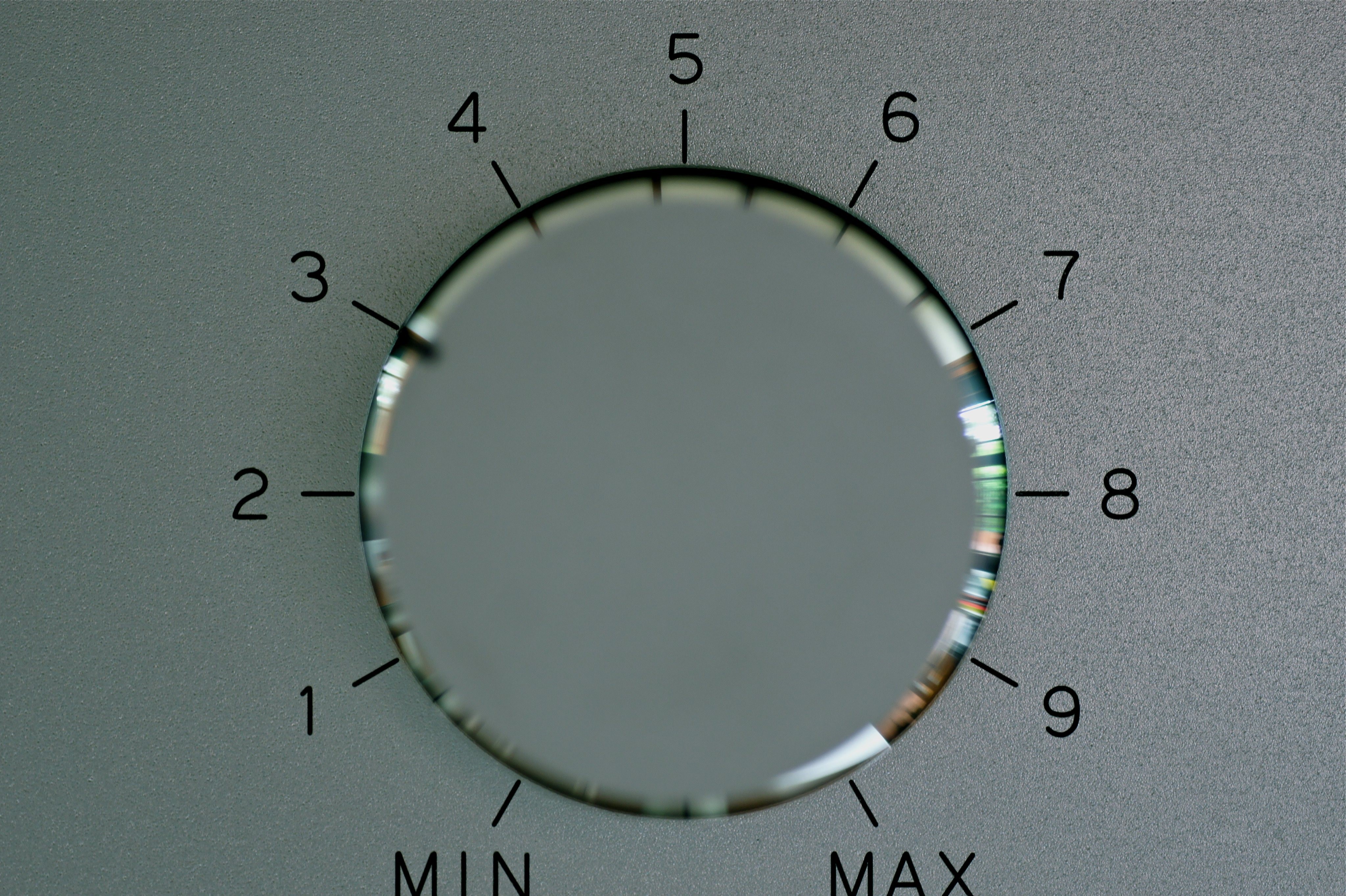 Close-up of a gray rotary dial with numbers and MIN/MAX settings HD Wallpaper