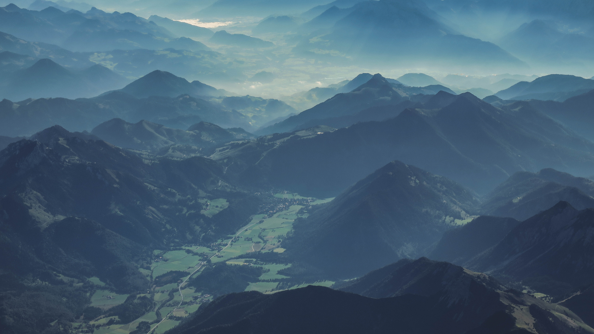 Aerial view of misty mountains and valleys in Austria HD Wallpaper