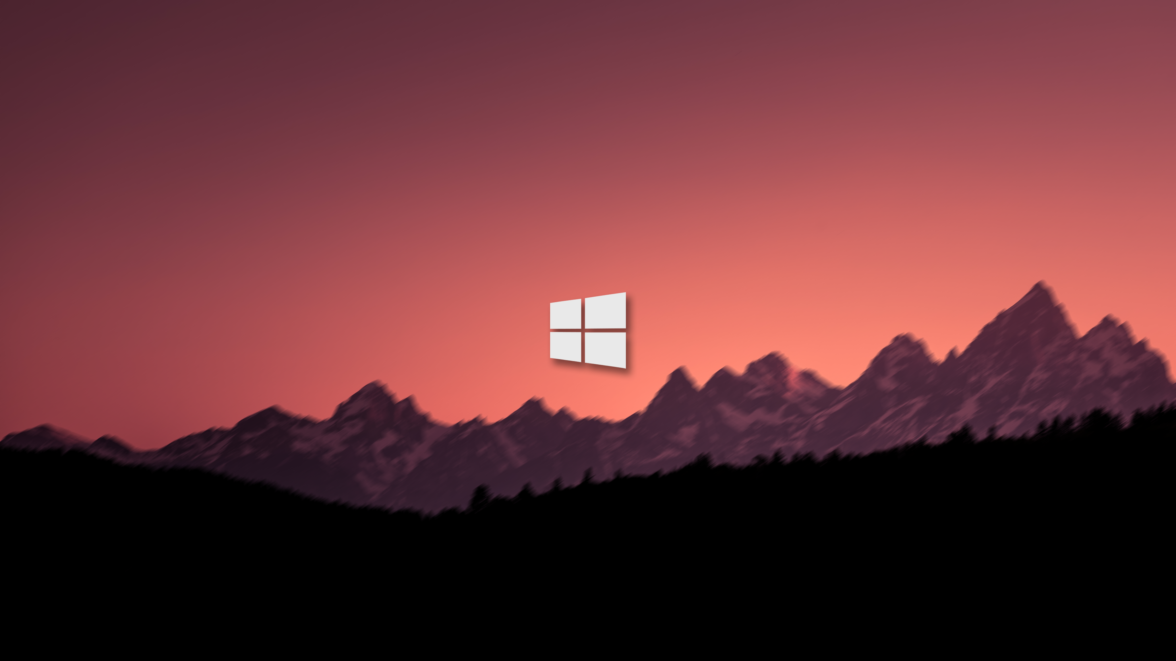 Microsoft Windows logo over blurred mountains at sunset HD Wallpaper