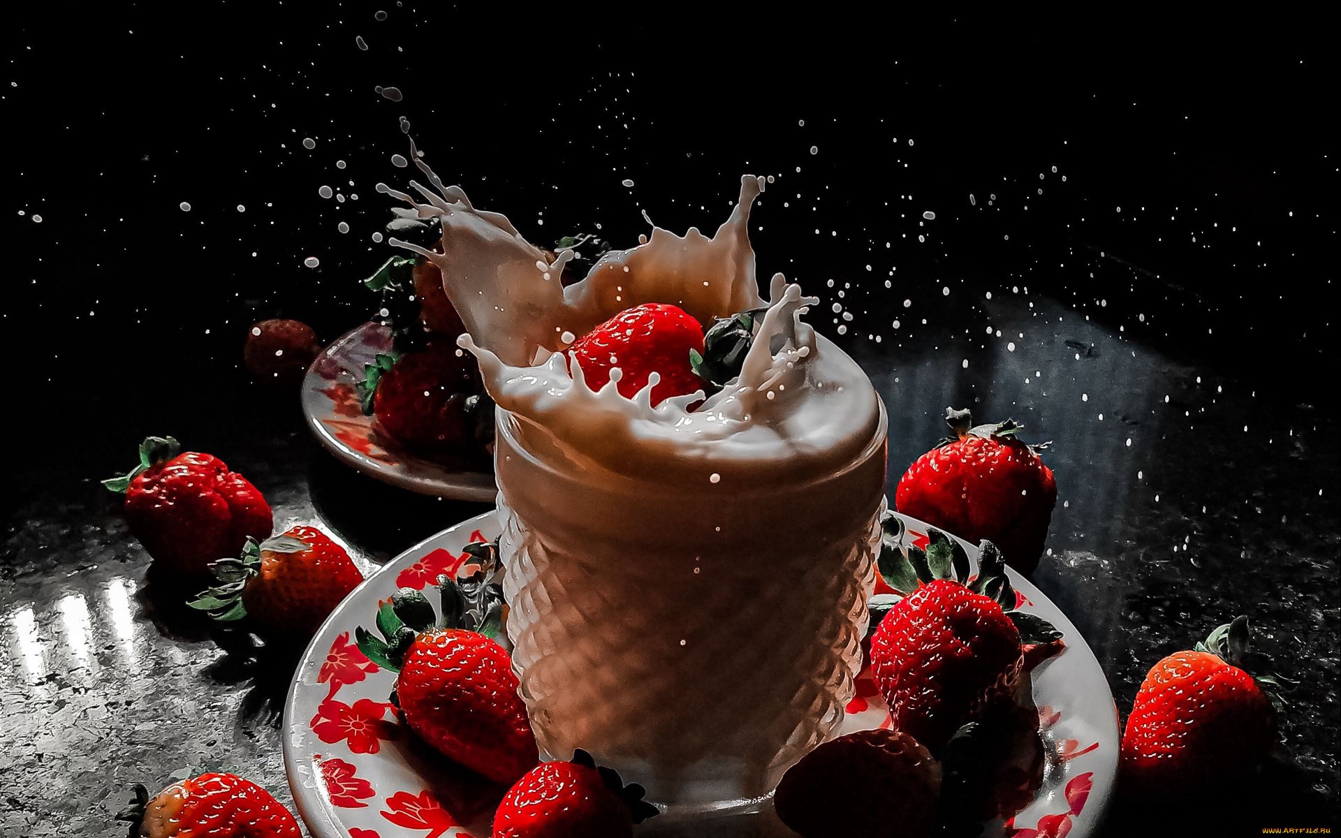Strawberries splashing into milk in a glass HD Wallpaper