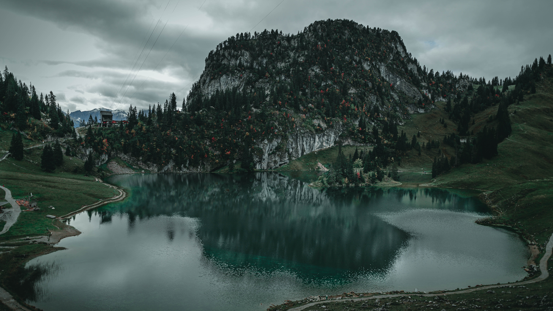 Lake and mountain landscape with clouds and power lines in Switzerland HD Wallpaper