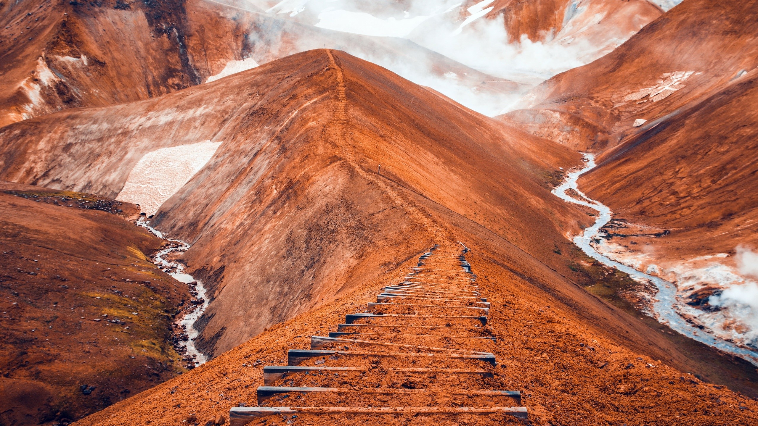 Orange mountains with a winding path and stream in Iceland HD Wallpaper