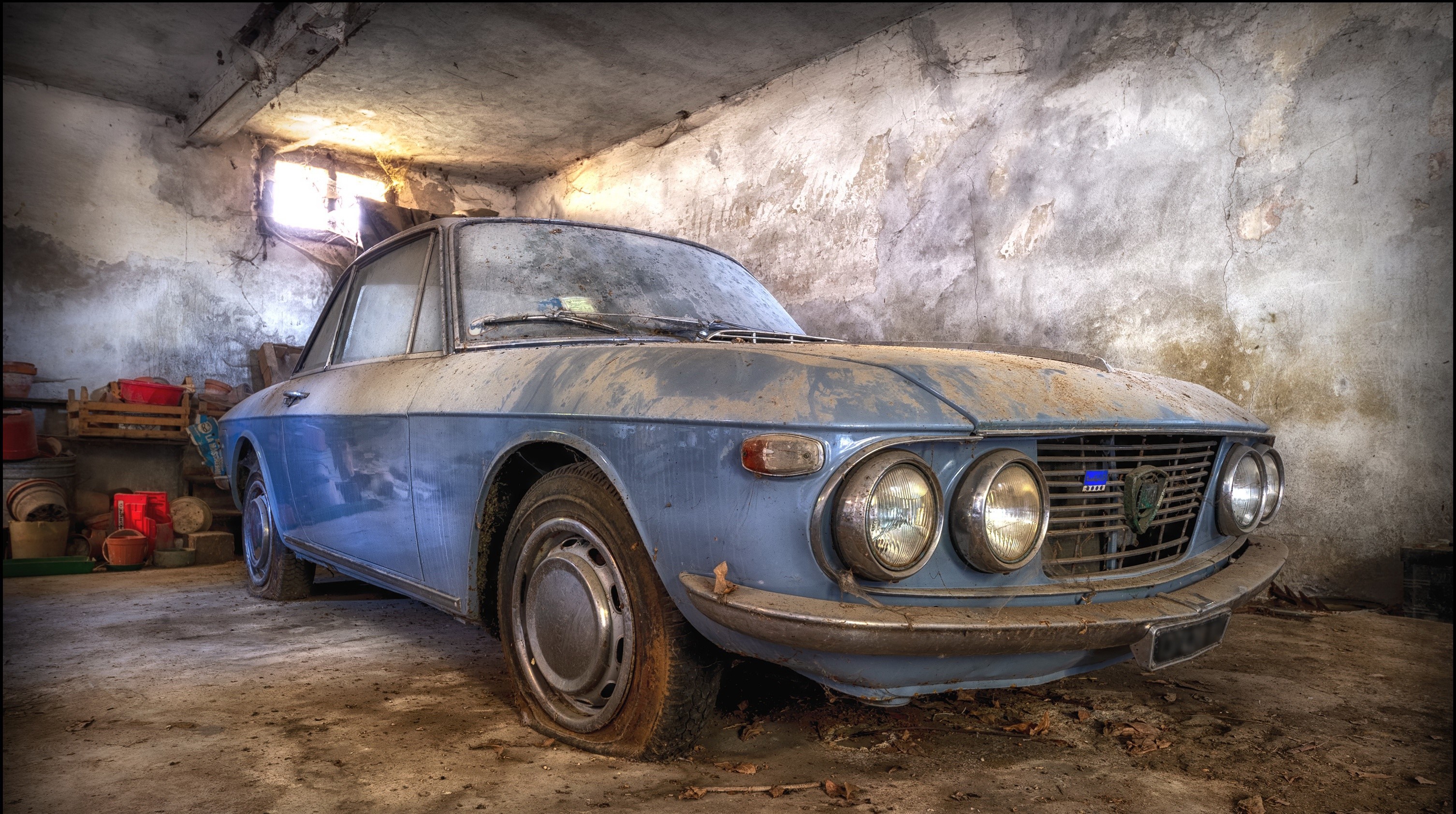Abandoned blue Lancia Fulvia coupe in a dusty garage HD Wallpaper