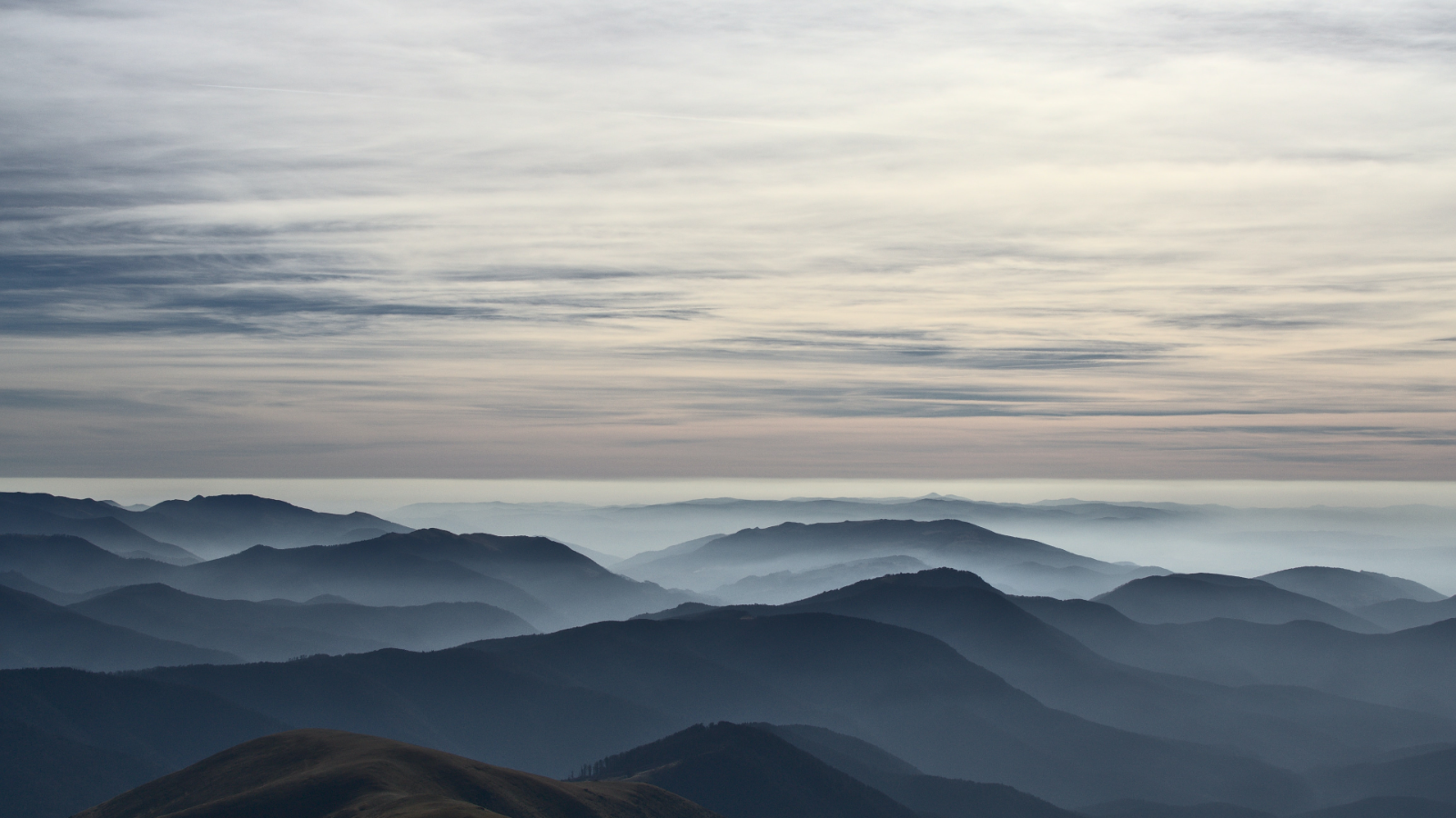 Tarcului Mountains landscape with mist and clouds HD Wallpaper