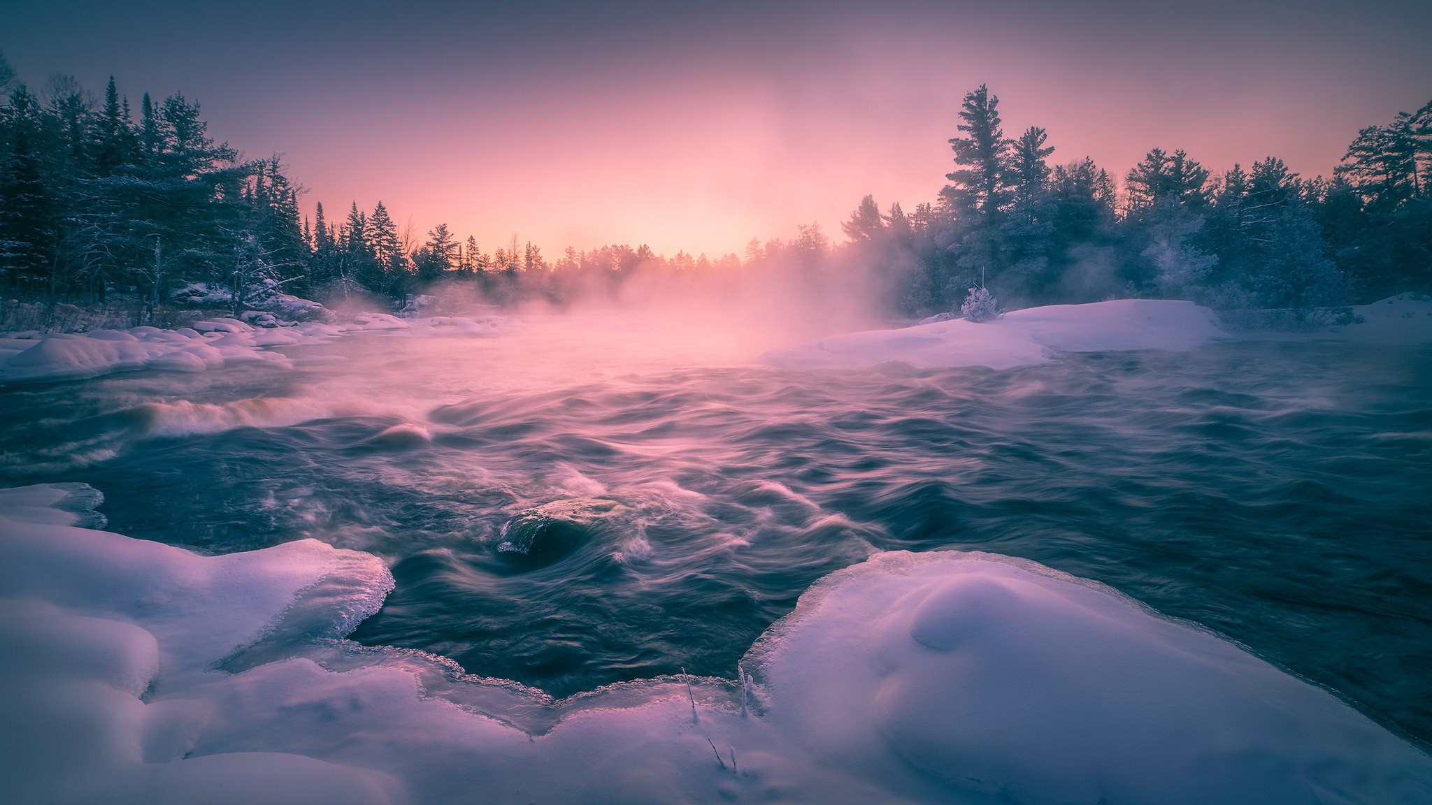 Misty river flowing through a snowy forest at sunrise HD Wallpaper