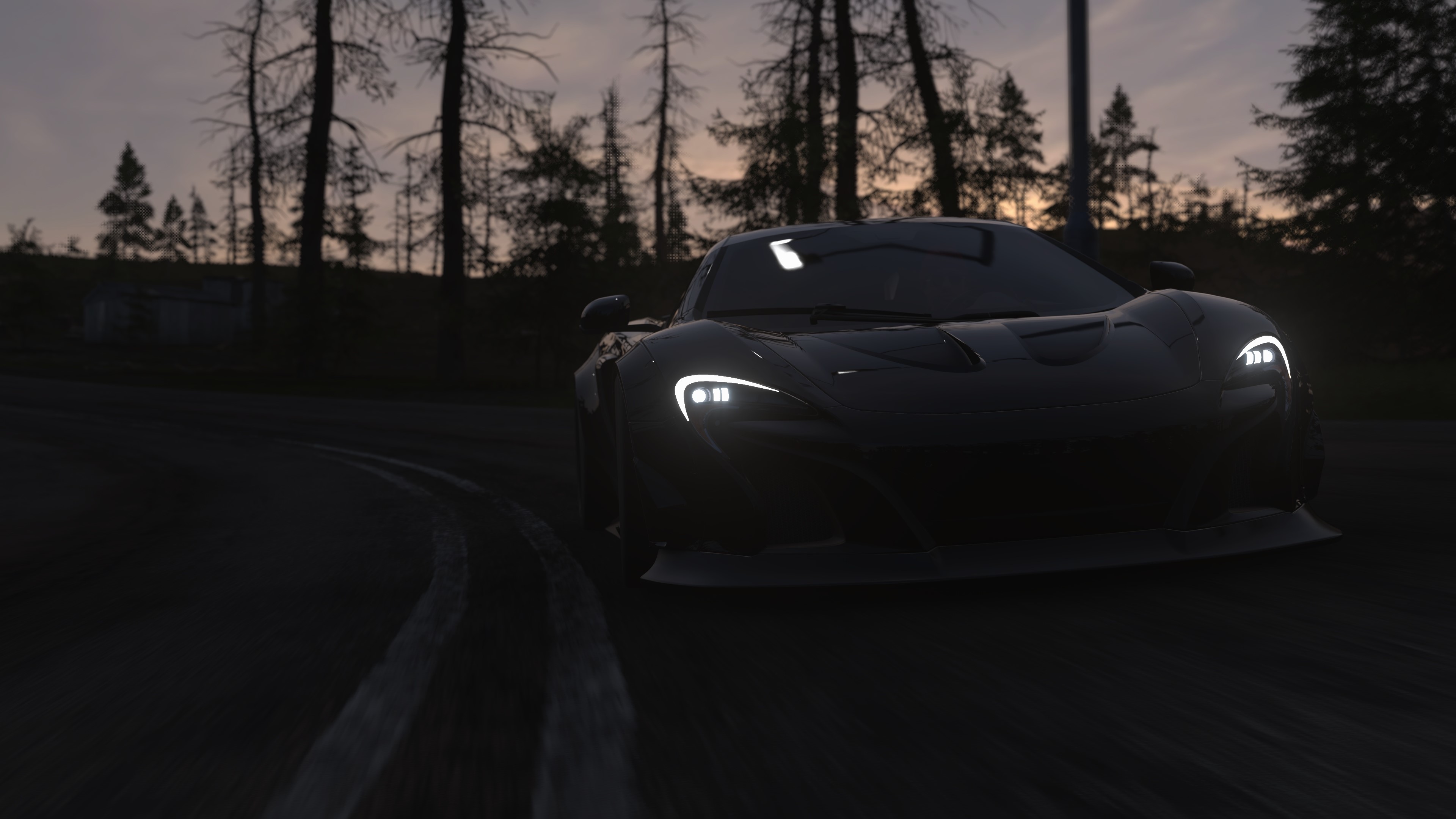 Black McLaren sports car on a road at dusk HD Wallpaper