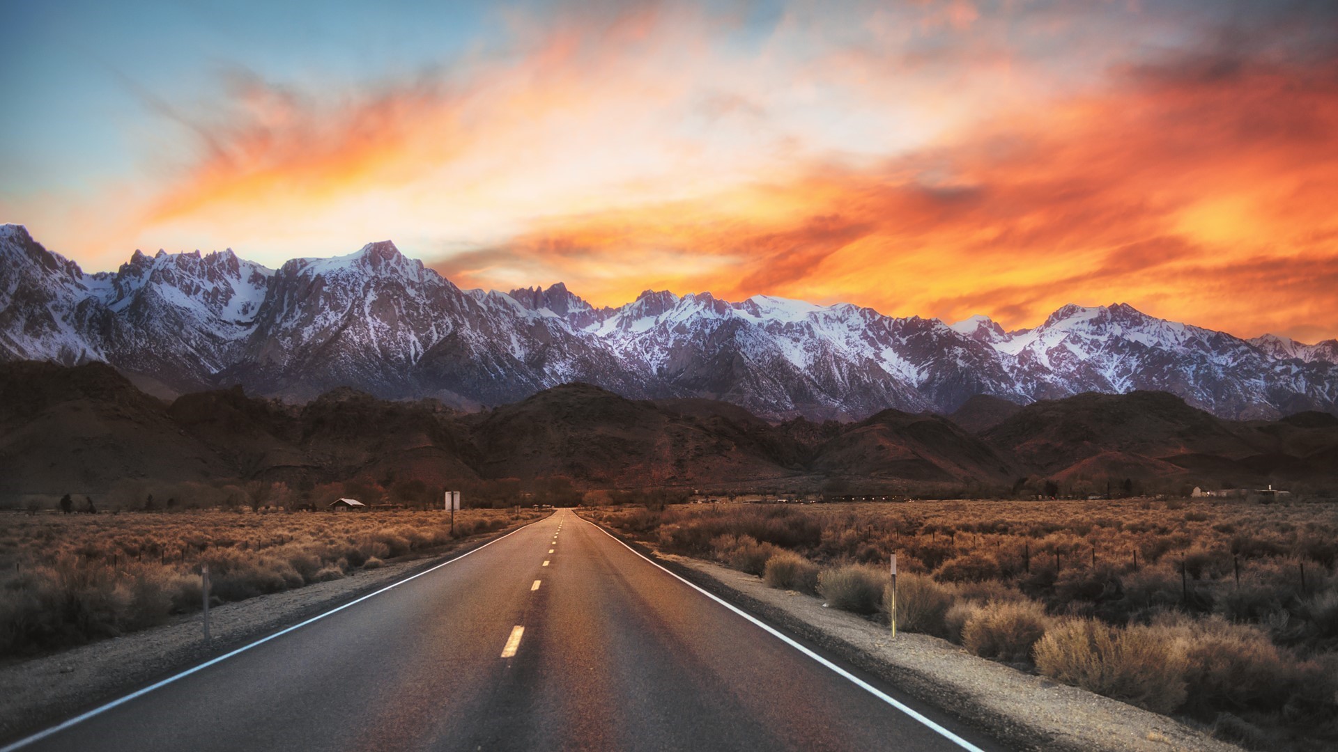 Road leading to snow-capped mountains at sunrise in California HD Wallpaper