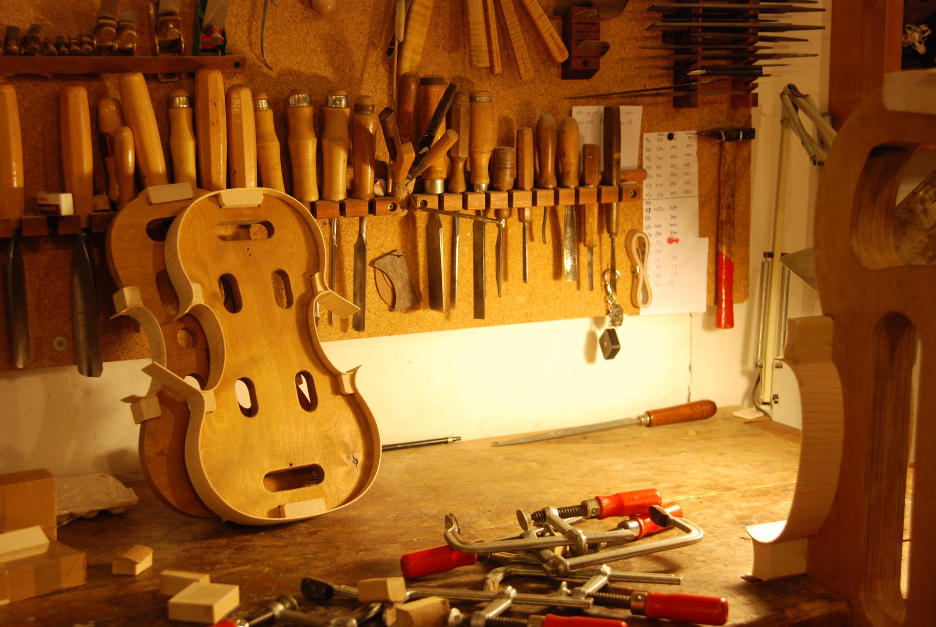 Violin workshop with tools and unfinished instrument HD Wallpaper
